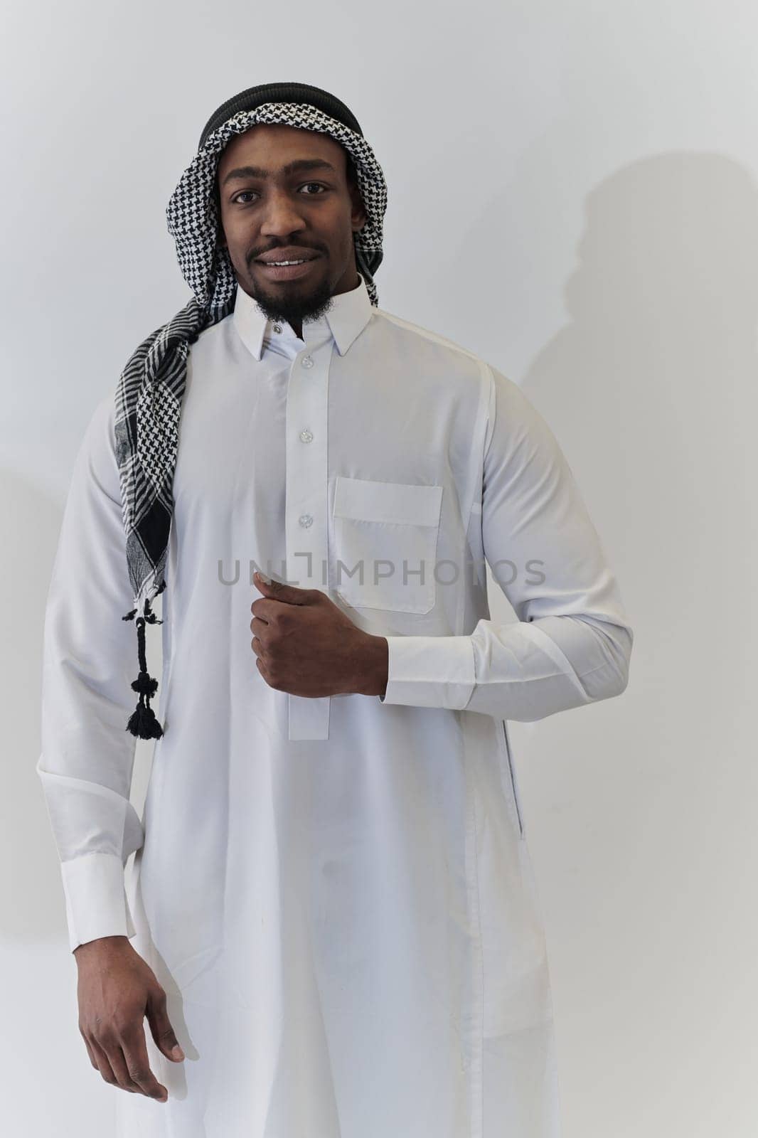 Arabic entrepreneur captures a self-portrait against an isolated white background, radiating ambition, determination, and corporate charisma, embodying the essence of a successful and influential business leader.