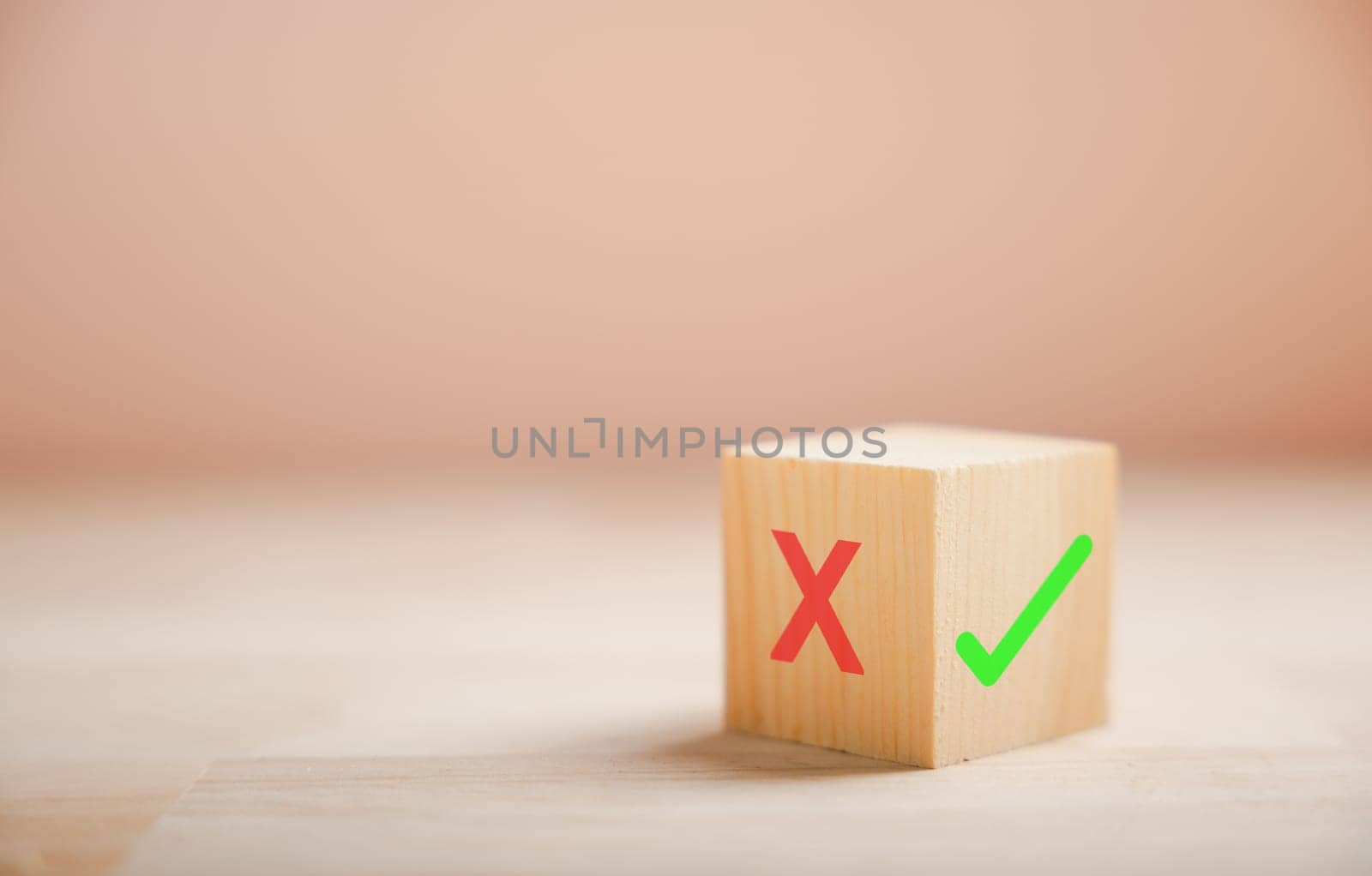 Decision-making concept portrayed by wooden block's green check mark and red x. Choice symbolism shown. Think With Yes Or No Choice.