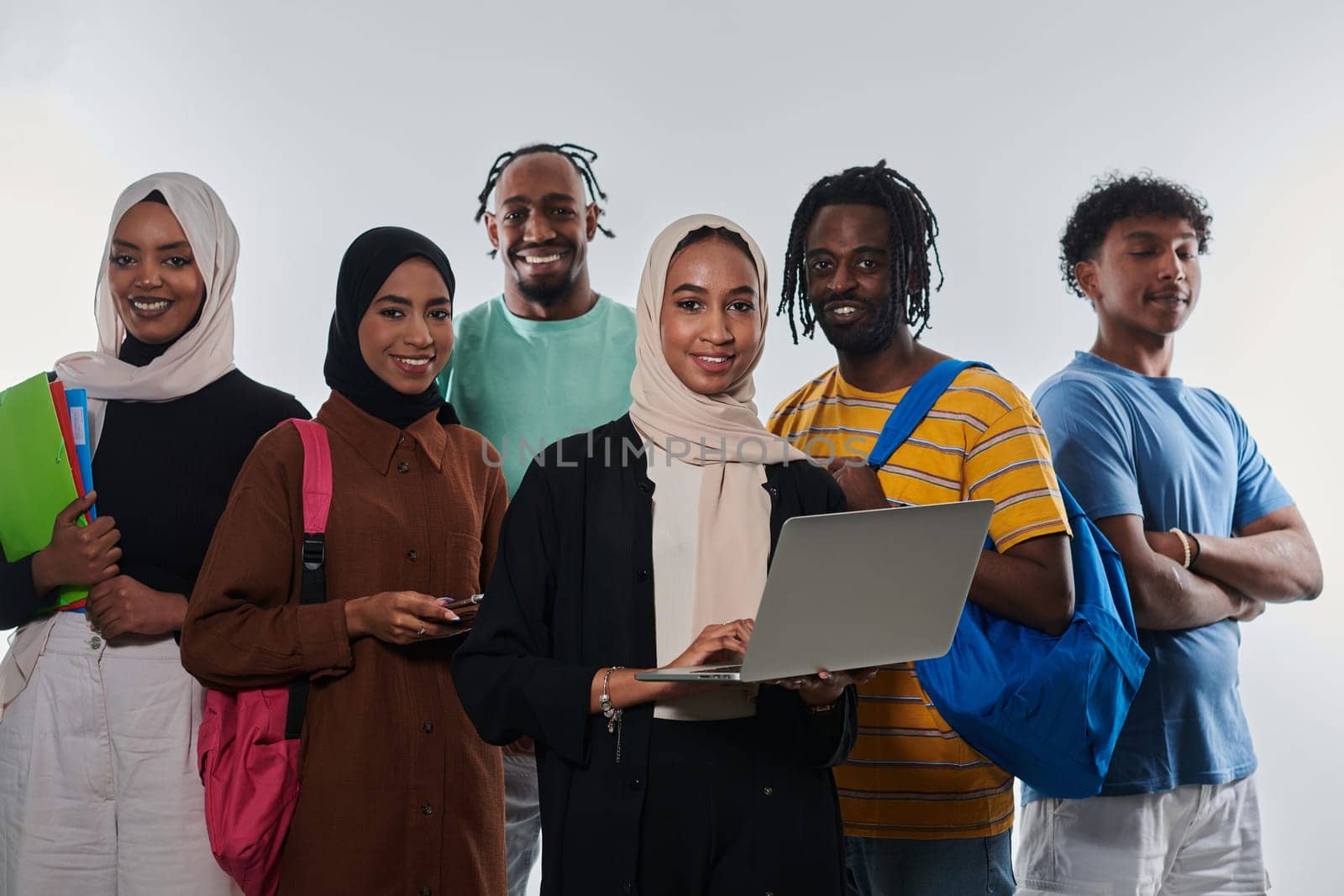 Group of diverse students engages in modern educational practices, utilizing a variety of technological tools such as laptops, tablets, and smartphones against a clean white background, exemplifying the contemporary approach to collaborative learning and information access.