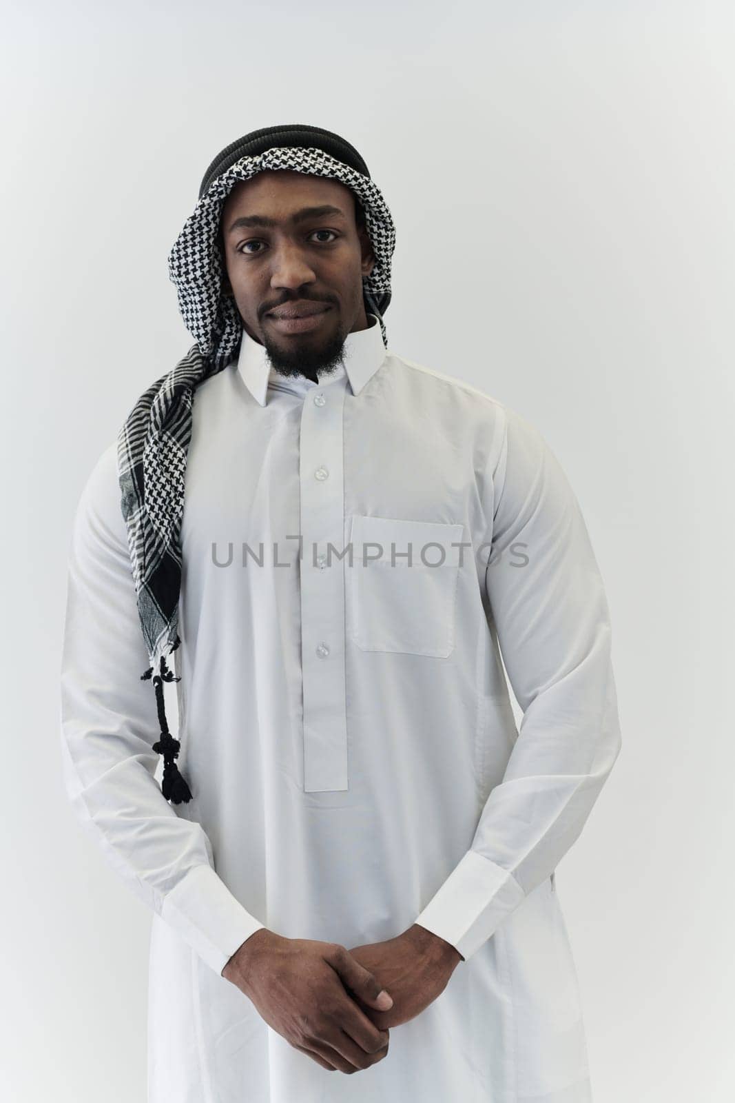 Arabic entrepreneur captures a self-portrait against an isolated white background, radiating ambition, determination, and corporate charisma, embodying the essence of a successful and influential business leader by dotshock