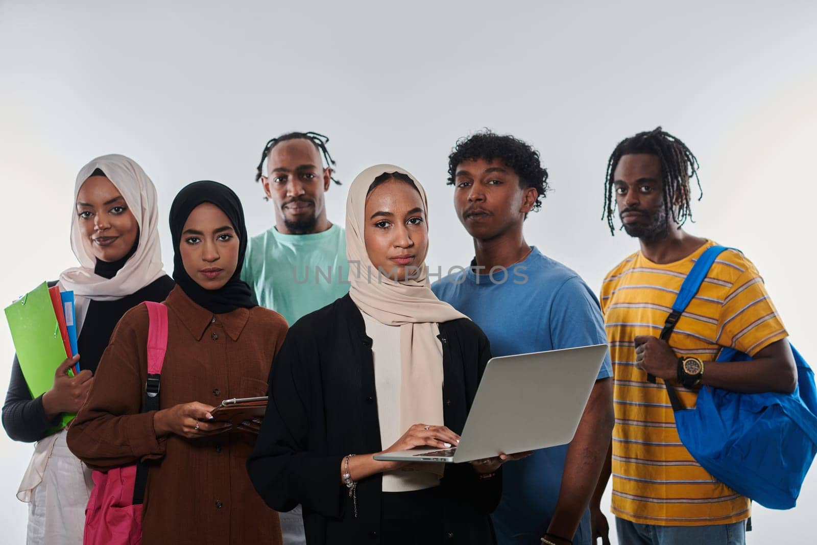 Group of diverse students engages in modern educational practices, utilizing a variety of technological tools such as laptops, tablets, and smartphones against a clean white background, exemplifying the contemporary approach to collaborative learning and information access.