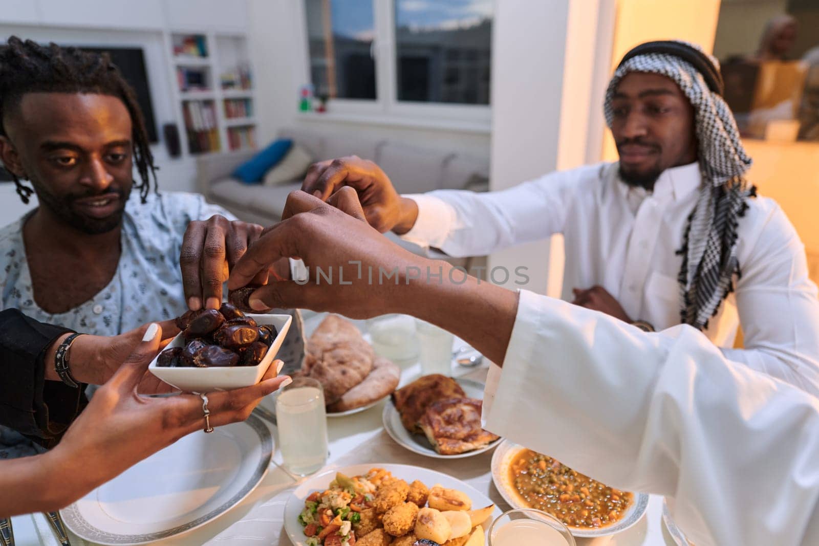 In a poignant close-up, the diverse hands of a Muslim family delicately grasp fresh dates, symbolizing the breaking of the fast during the holy month of Ramadan, capturing a moment of cultural unity, shared tradition, and the joyous anticipation of communal iftar.