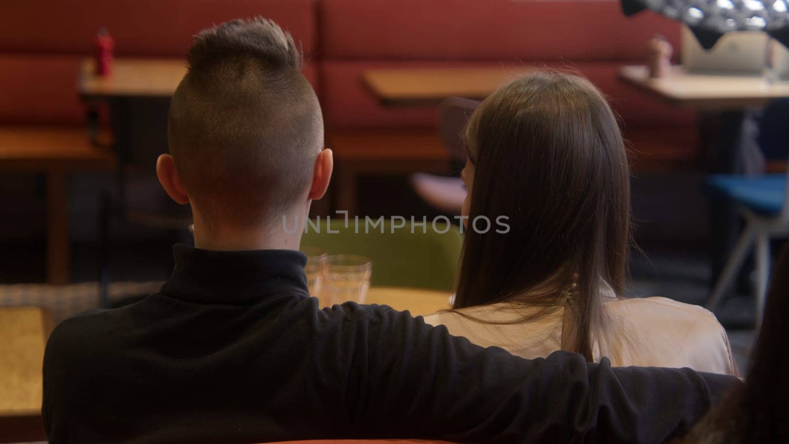 Beautiful young couple on date in cafe. Stock footage. Young couple is having nice time on date in cafe. Date of young couple in cafe by Mediawhalestock