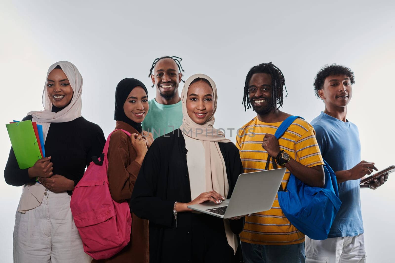 Group of diverse students engages in modern educational practices, utilizing a variety of technological tools such as laptops, tablets, and smartphones against a clean white background, exemplifying the contemporary approach to collaborative learning and information access.