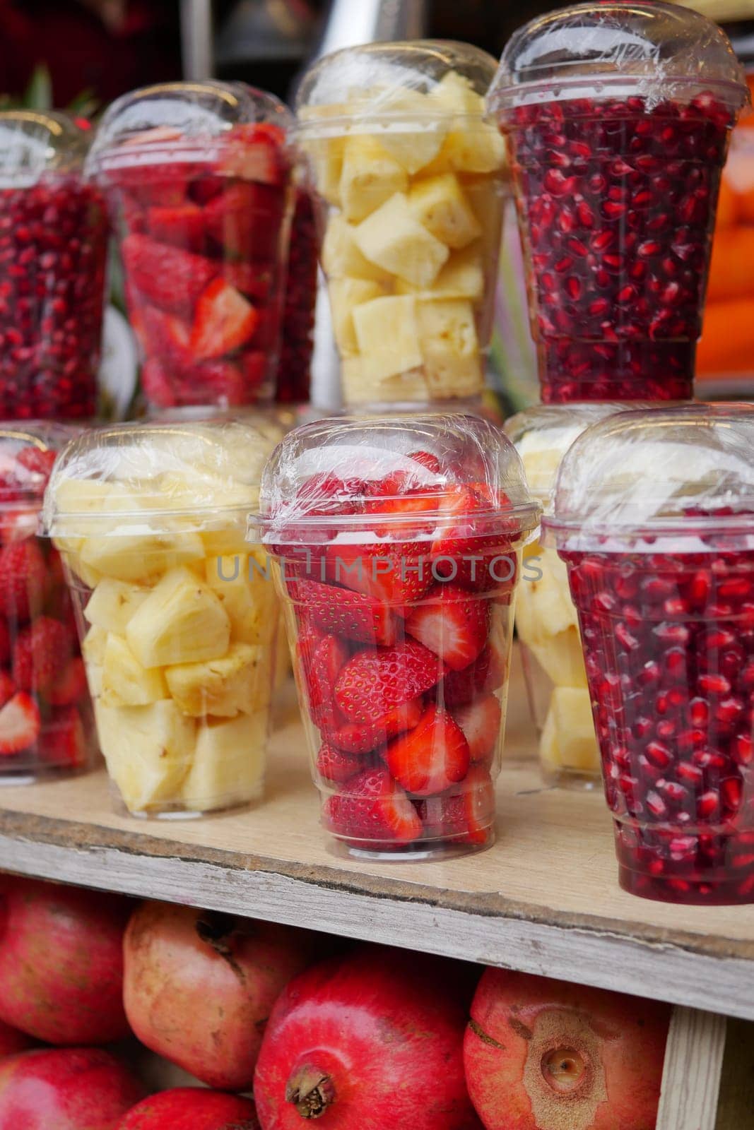 pineapple, kiwi and Strawberries in. plastic container selling at shop by towfiq007