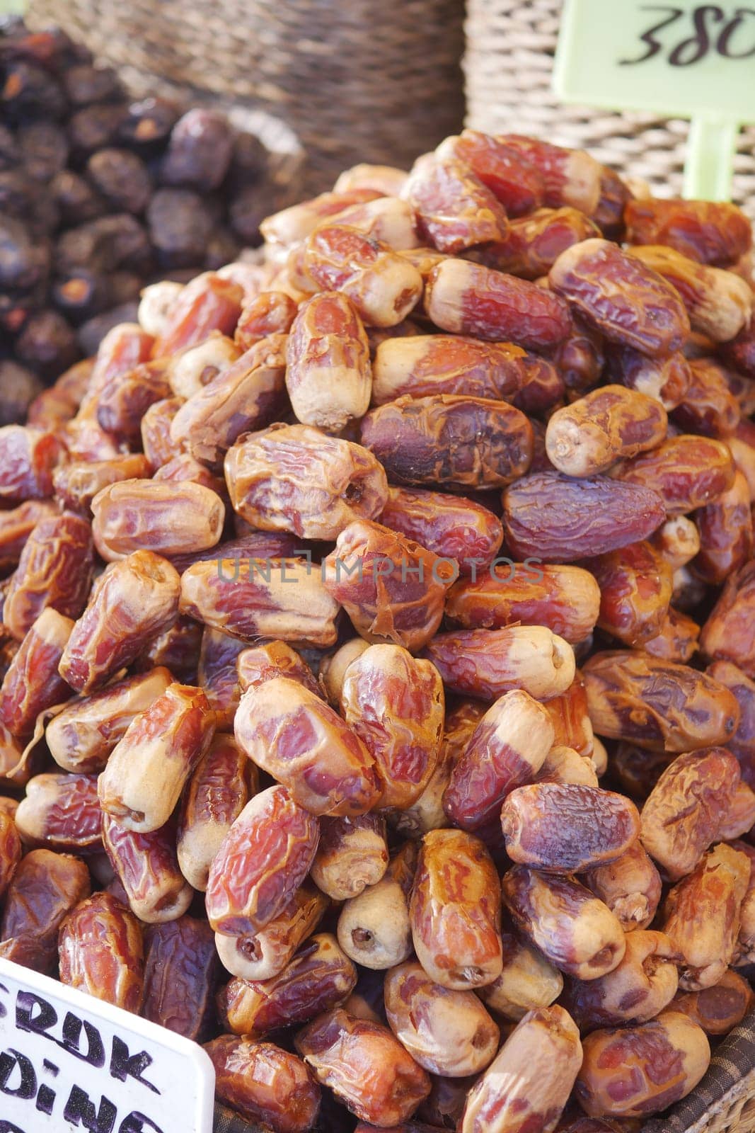 many date fruits display for sale at local market .