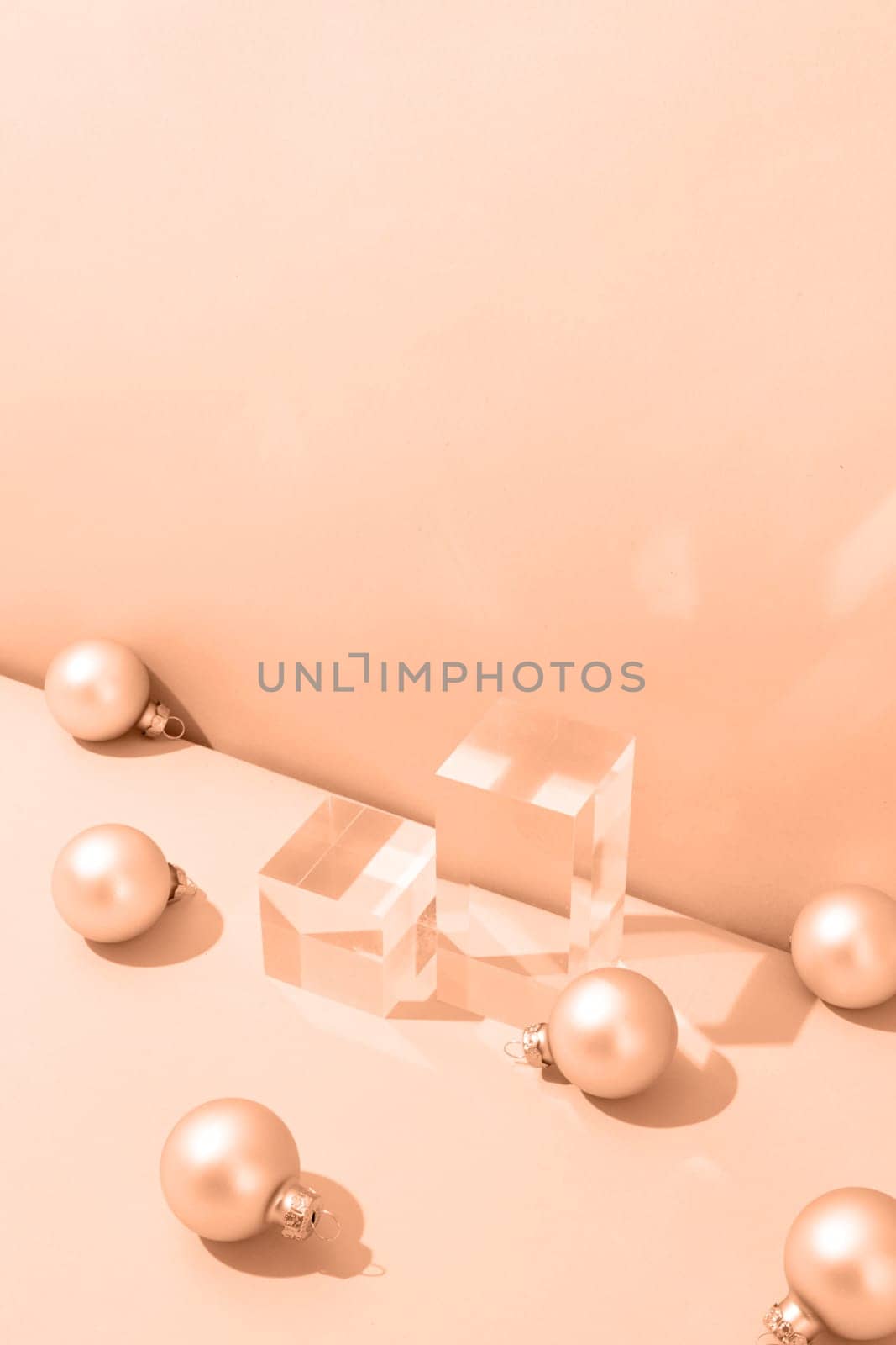 A minimalistic scene of glass podium with christmas pine tree and balls on beige background by Desperada