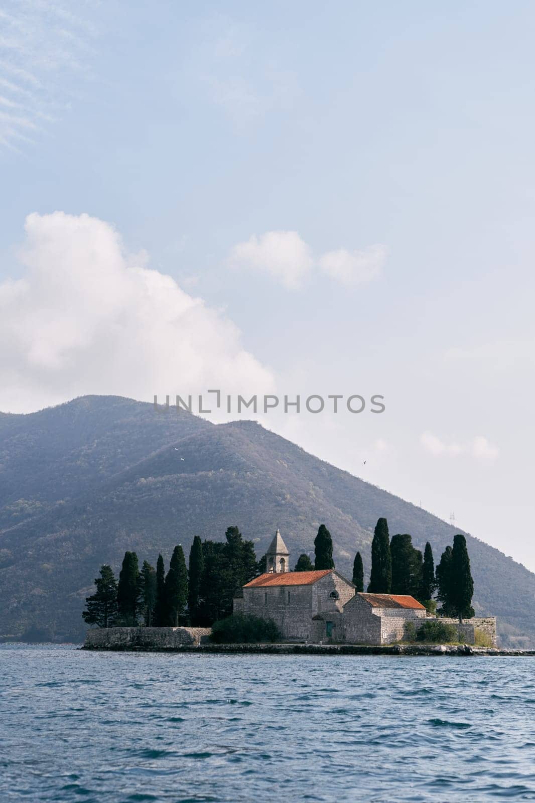 Island of St. George in the Bay of Kotor with mountains in the background. Montenegro. High quality photo