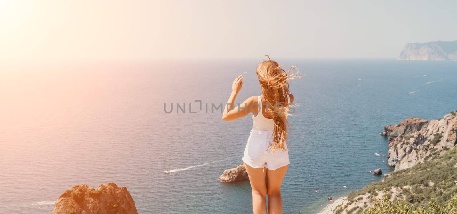 Woman summer travel sea. Happy tourist enjoy taking picture outdoors for memories. Woman traveler posing over sea bay surrounded by volcanic mountains, sharing travel adventure journey by panophotograph