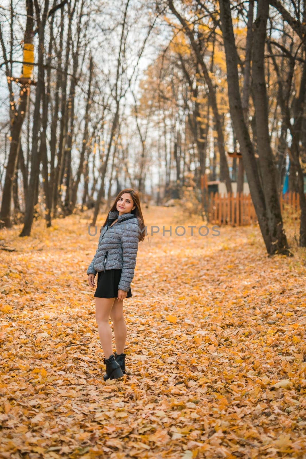Rear view portrait of diversity young beautiful confident Indian Asian woman in fall outdoor. Happy and natural smiling female. Generation z and gen z youth concept by Satura86