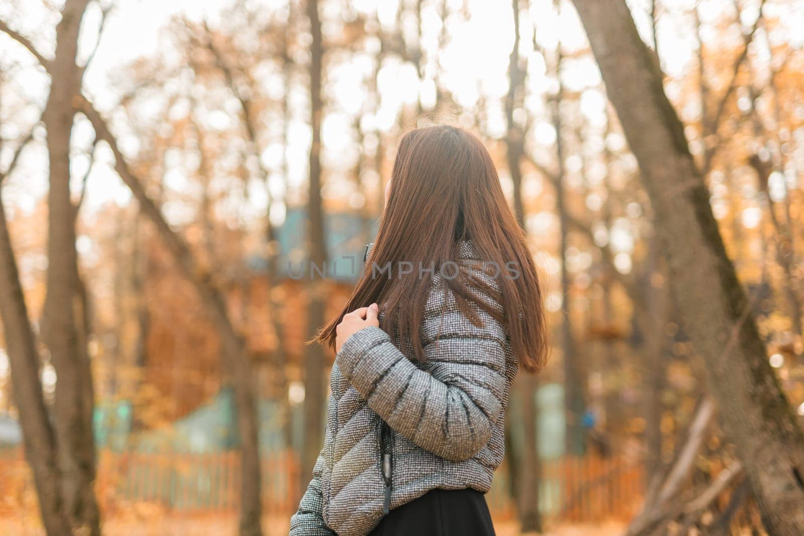 Close-up portrait of a young beautiful confident Indian Asian woman in fall outdoor. Happy and natural smiling female. Generation z and gen z youth