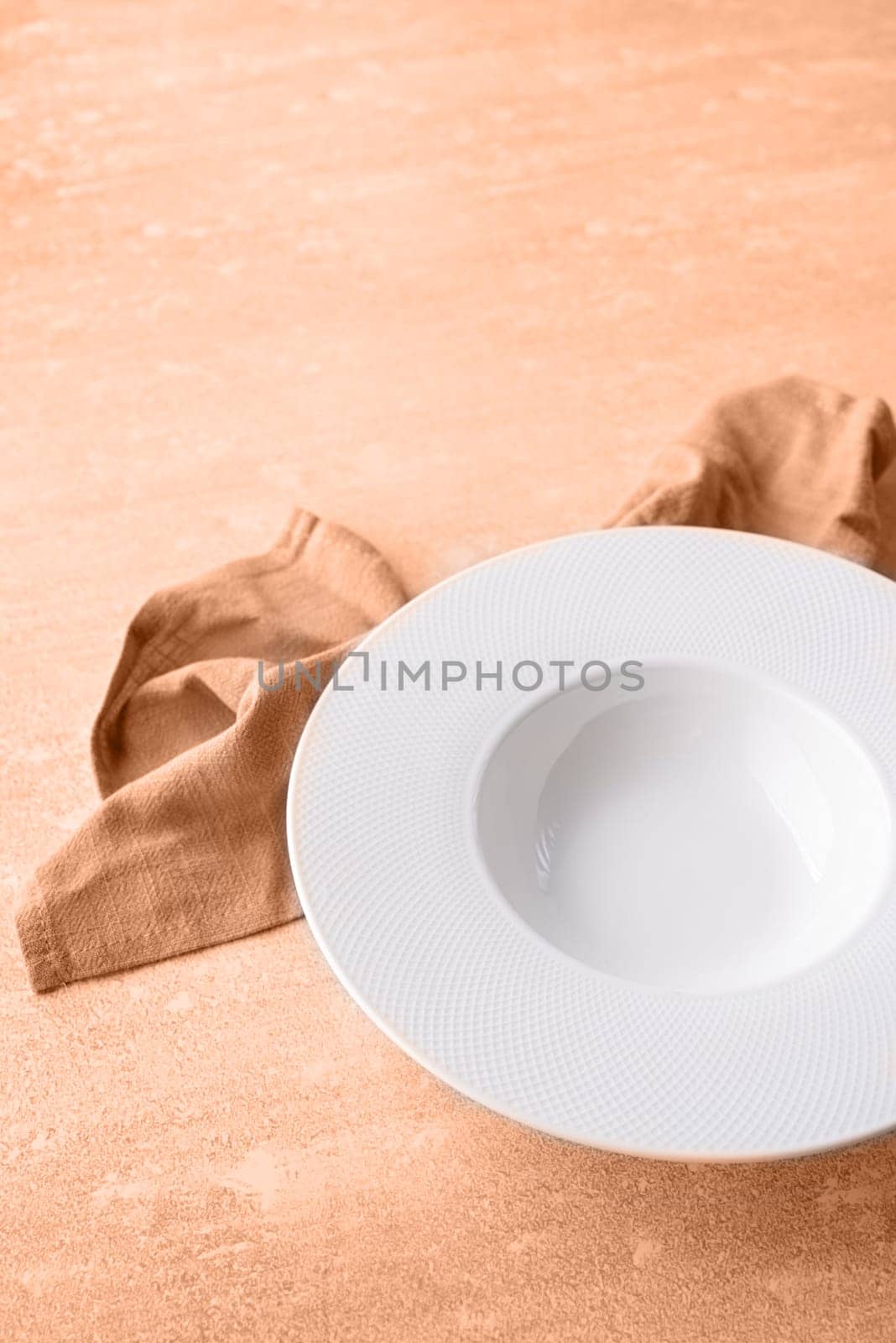 Color of the year 2024: Peach Fuzz. Plate of typical food Italian, empty plate for serving pasta or soup