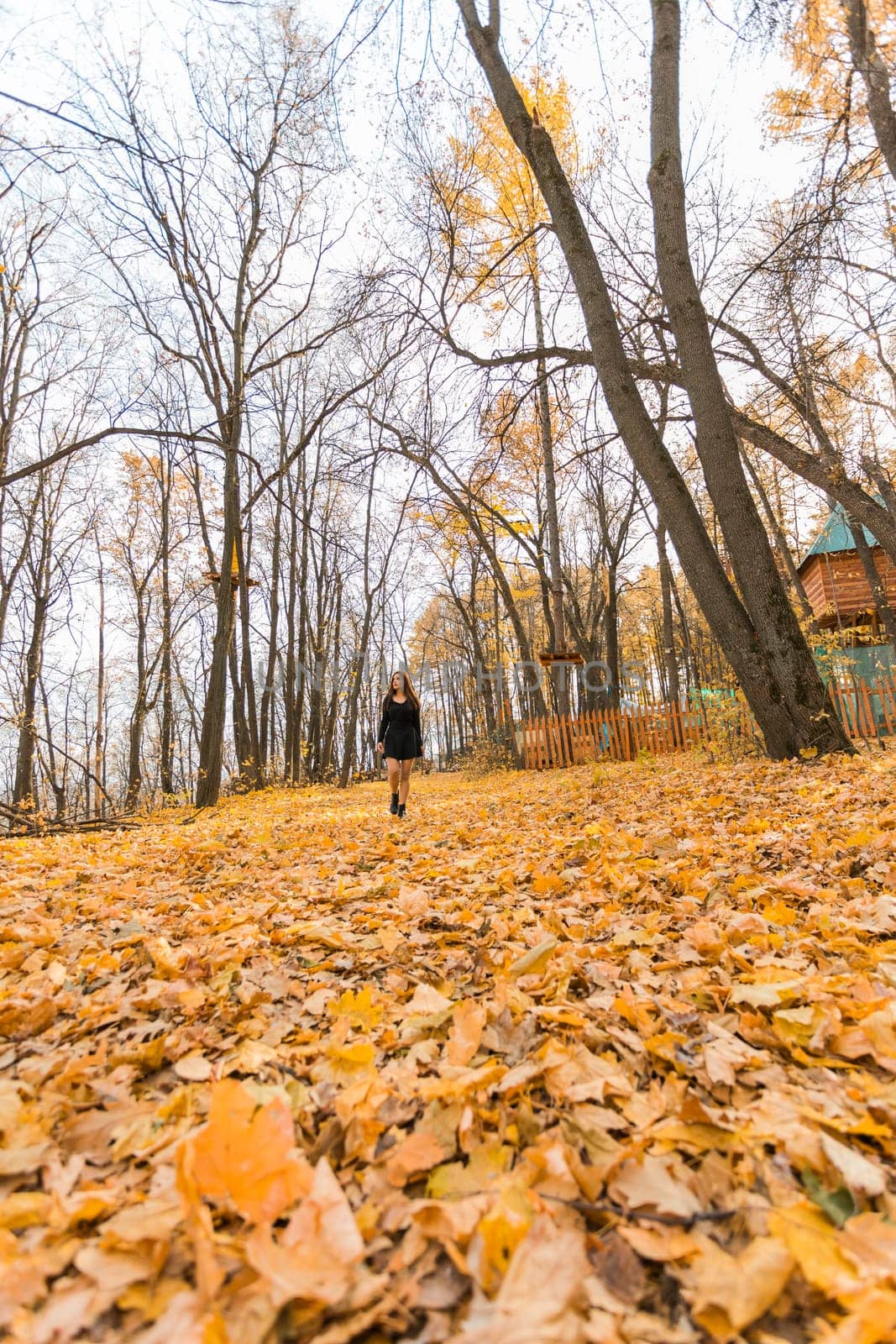 Close-up portrait of a young beautiful confident Indian Asian woman in fall outdoor. Happy and natural smiling female. Generation z and gen z youth