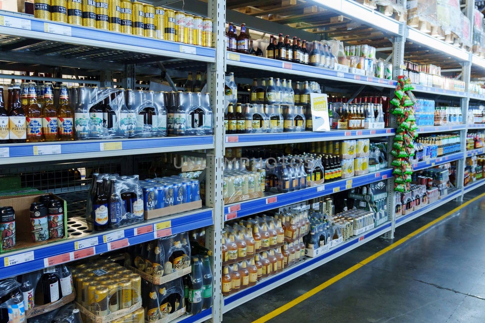 Tyumen, Russia-December 11, 2023: Shop counter. Beer in the window. Beer in bottles and tin cans. Selective focus by darksoul72