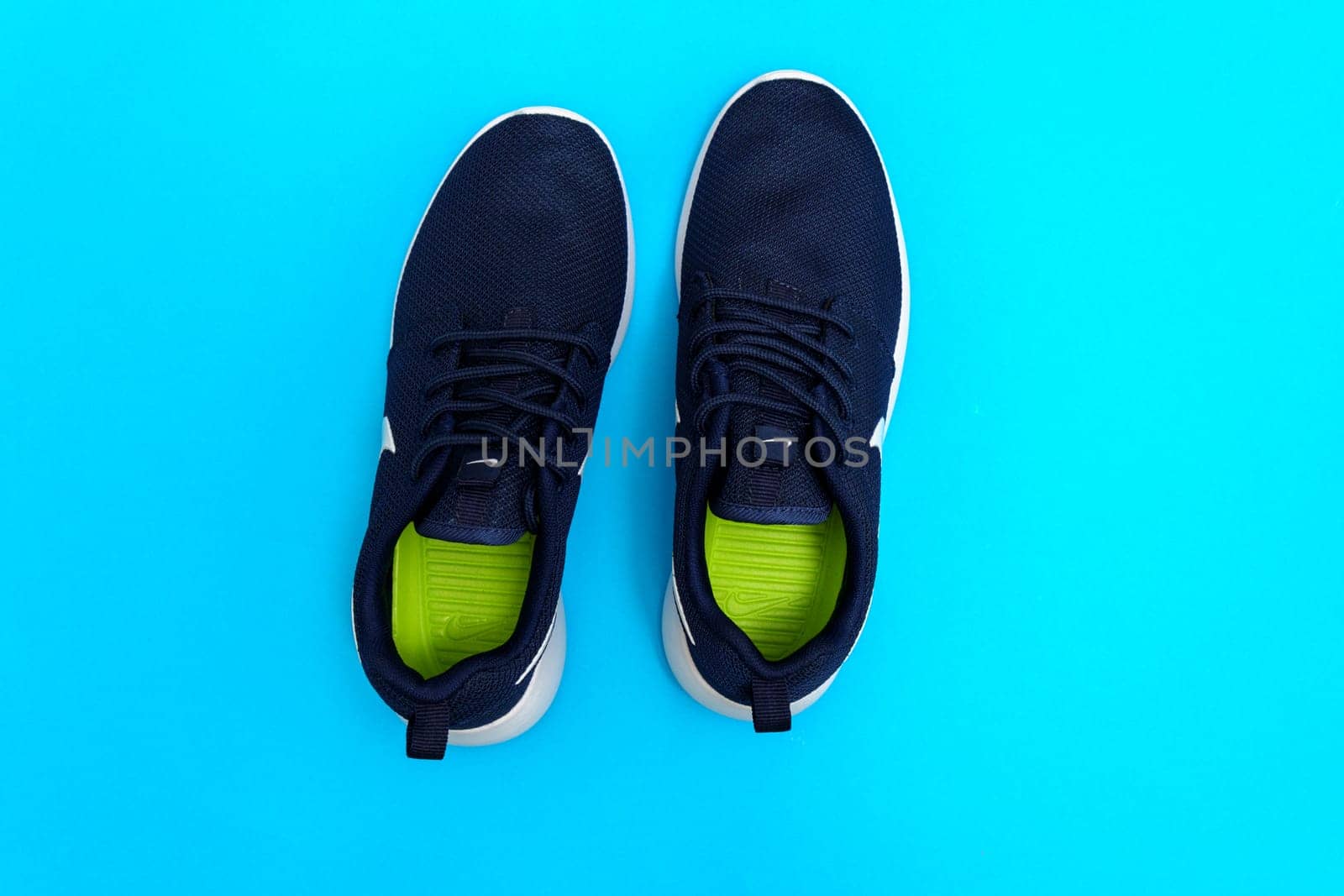 Tyumen, Russia-August 03, 2023: Nike sneakers for running, training, in blue background, showing the Nike logo by darksoul72