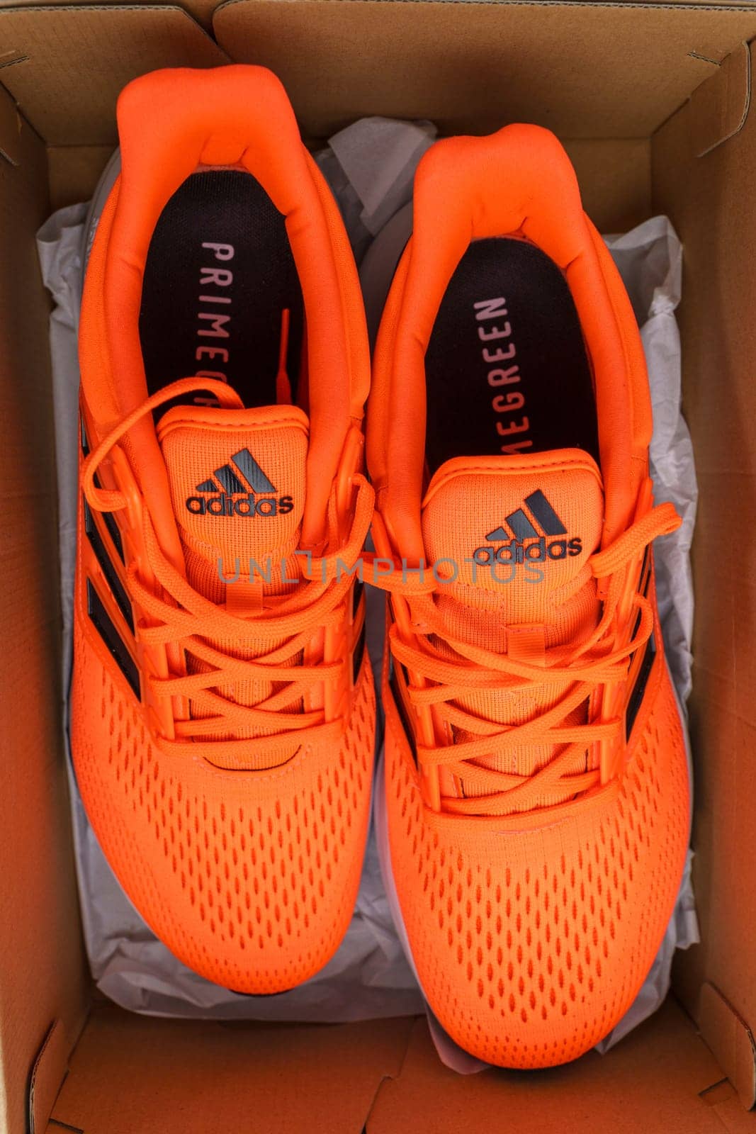 Tyumen, Russia-November 25, 2023: Orange Adidas Shoes in a Box. Selective focus by darksoul72