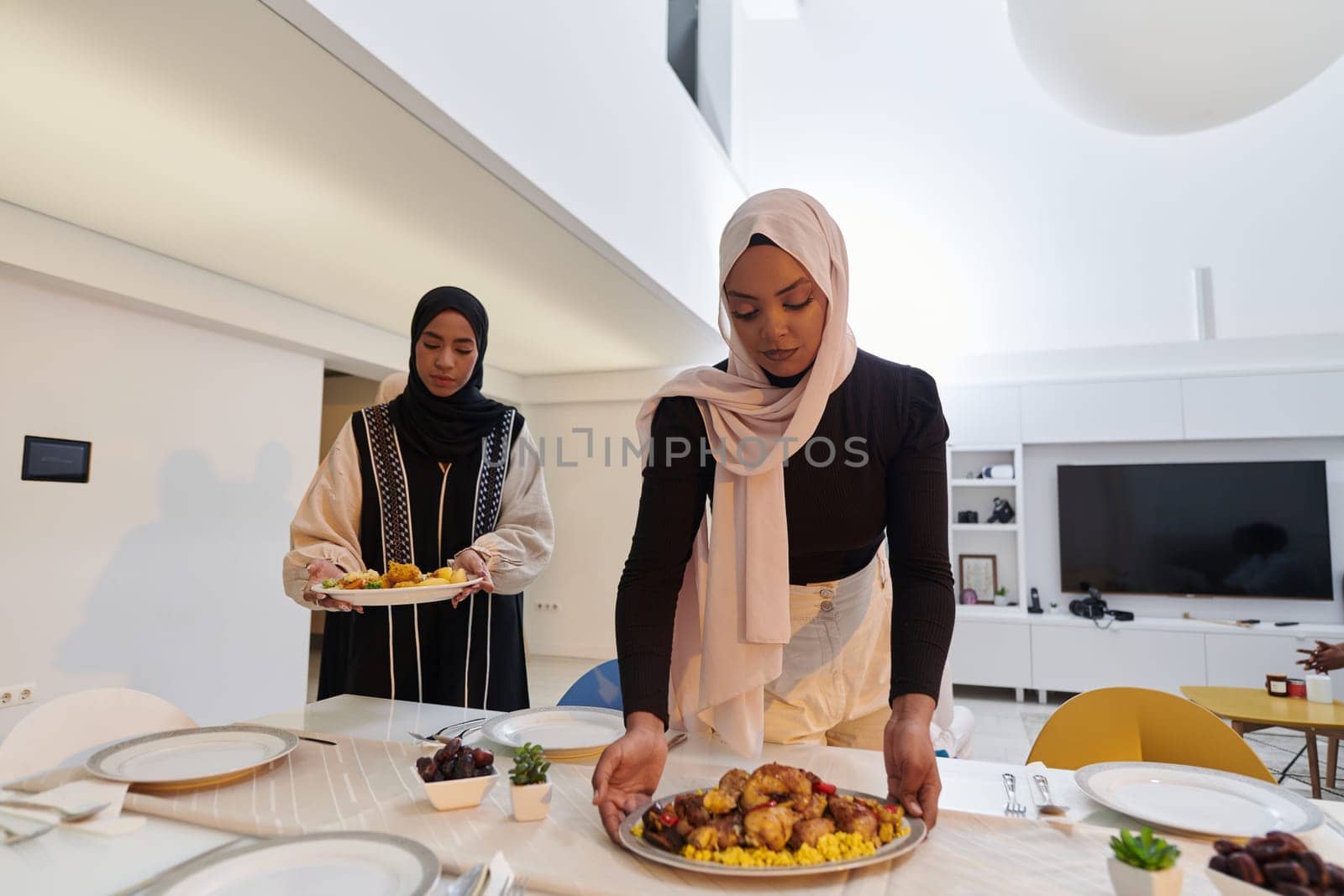 Group of young Arab women come together to lovingly prepare an iftar table during the sacred Muslim month of Ramadan, embodying the essence of communal unity, cultural tradition, and joyous anticipation in their culinary preparations by dotshock