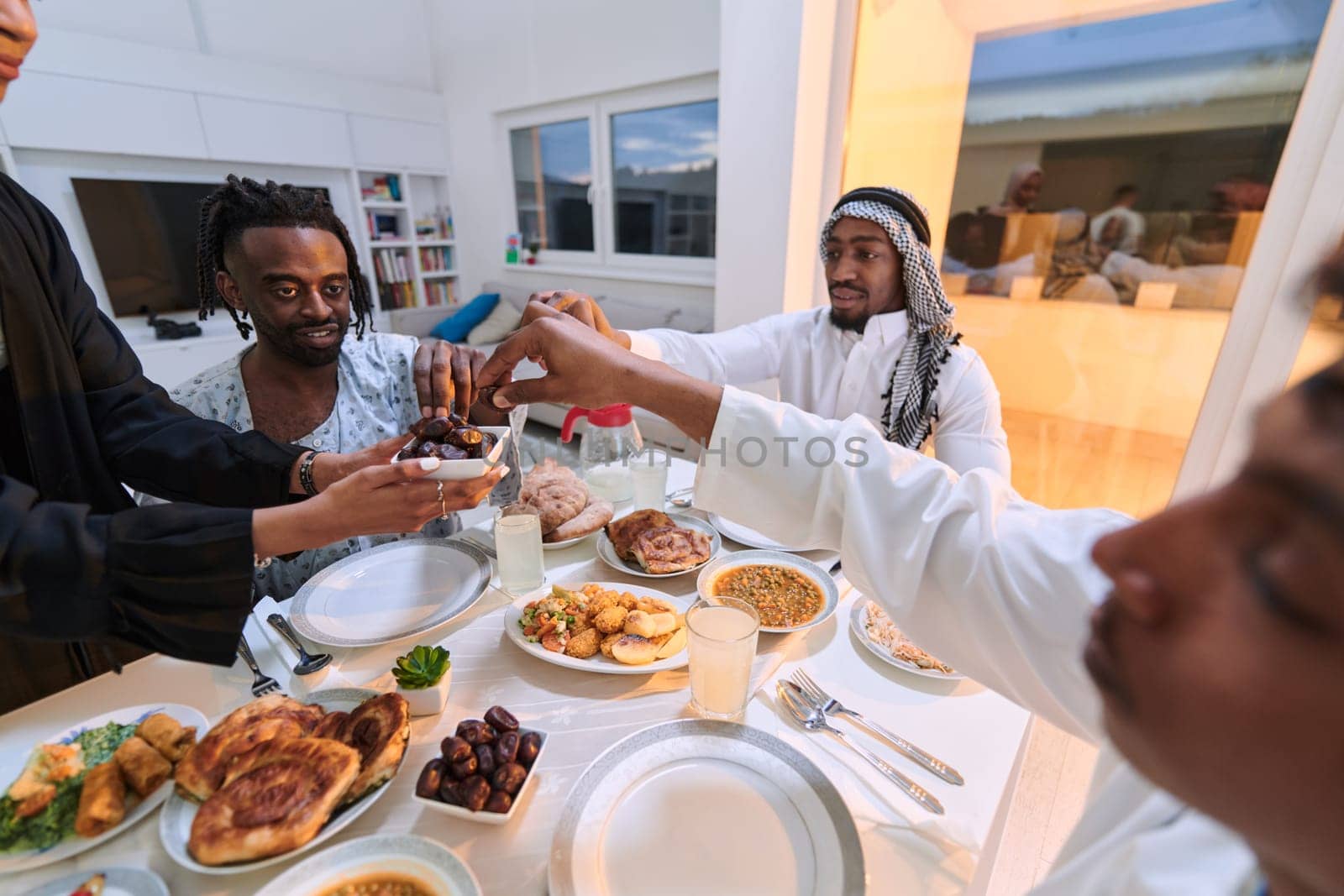 In a poignant close-up, the diverse hands of a Muslim family delicately grasp fresh dates, symbolizing the breaking of the fast during the holy month of Ramadan, capturing a moment of cultural unity, shared tradition, and the joyous anticipation of communal iftar.