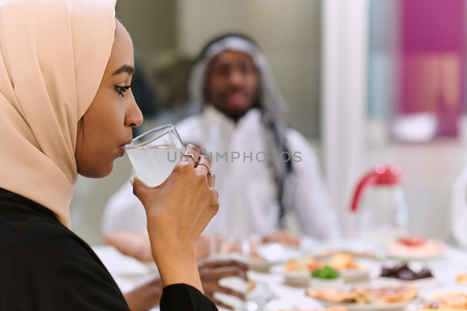 A traditional and diverse Muslim family comes together to share a delicious iftar meal during the sacred month of Ramadan, embodying the essence of familial joy, cultural richness, and spiritual unity in their shared celebration.