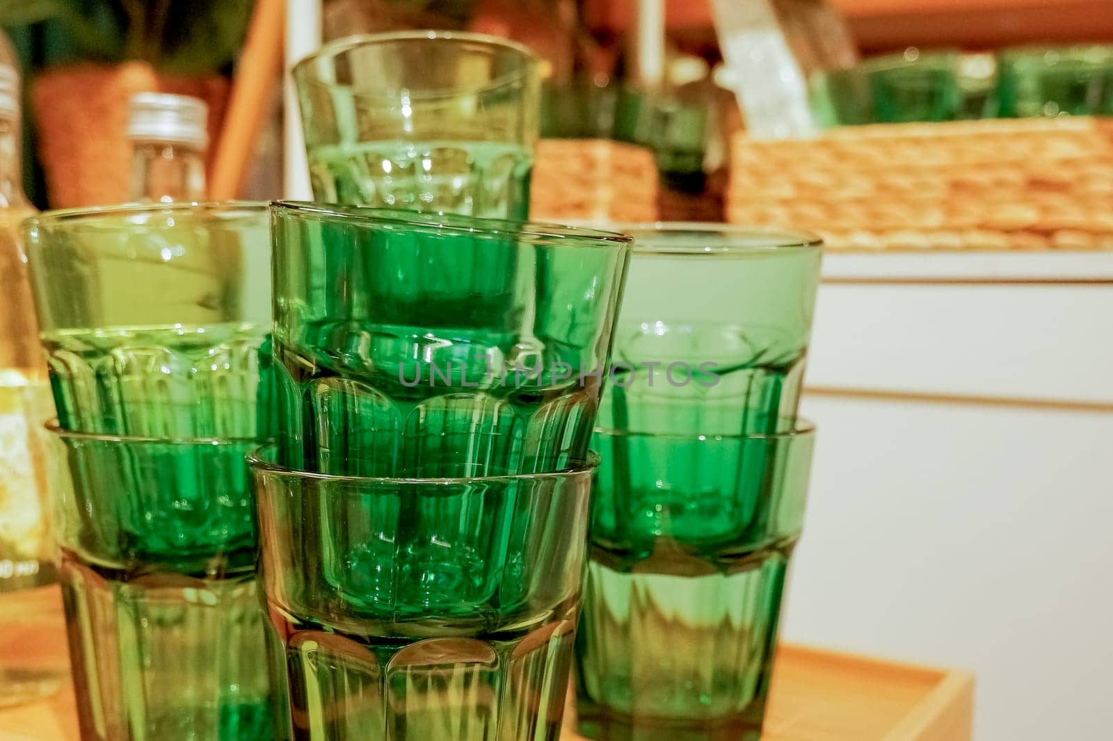 Stack of glasses on top of coffee machine in a coffee house.