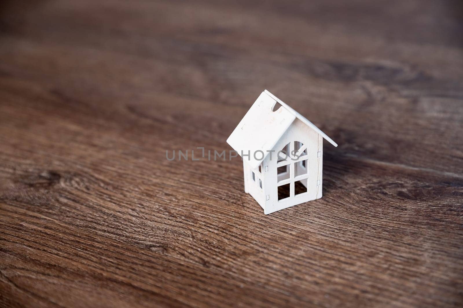 Model house isolated on wooden background