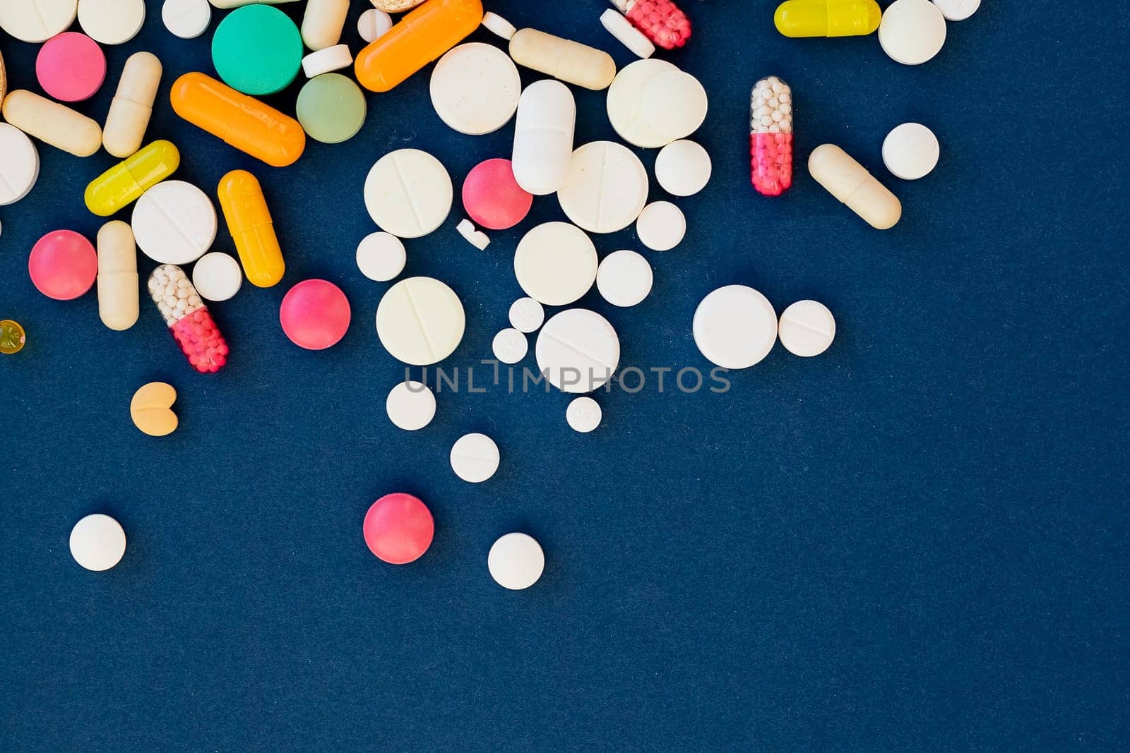 Assorted pharmaceutical colorful pills. Prevention, cure of influenza, coronavirus,antibiotics pills medicine. vitamins, tablets on blue background. medical healthcare, protection concept banner by YuliaYaspe1979