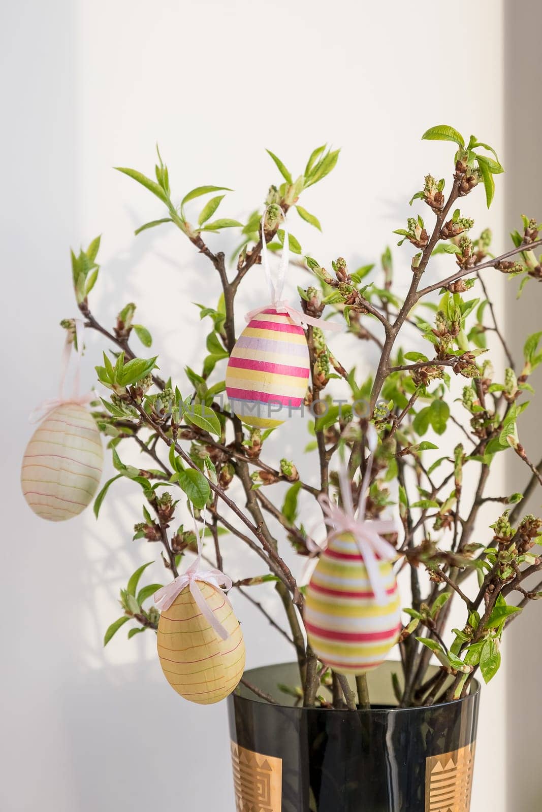 Easter eggs hanging on a spring blossom branch. Easter decorations. Easter background. Still life
