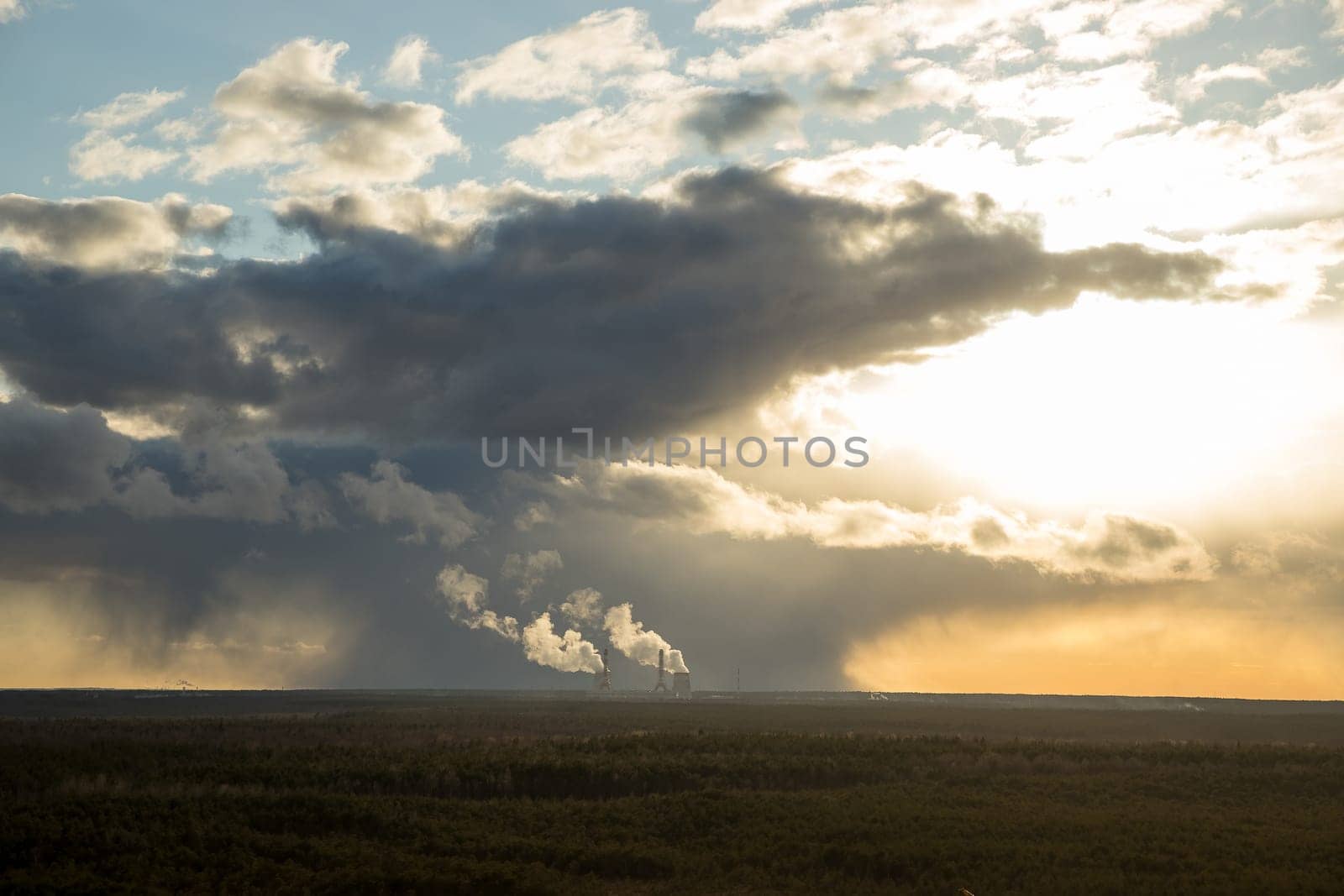 Smoking pipes of thermal power.Dramatic sunset sky.global warming plant landscape sunset orange ecology problem.Environment, ecology, pollution, alternative energy and natural gas production concepts by YuliaYaspe1979