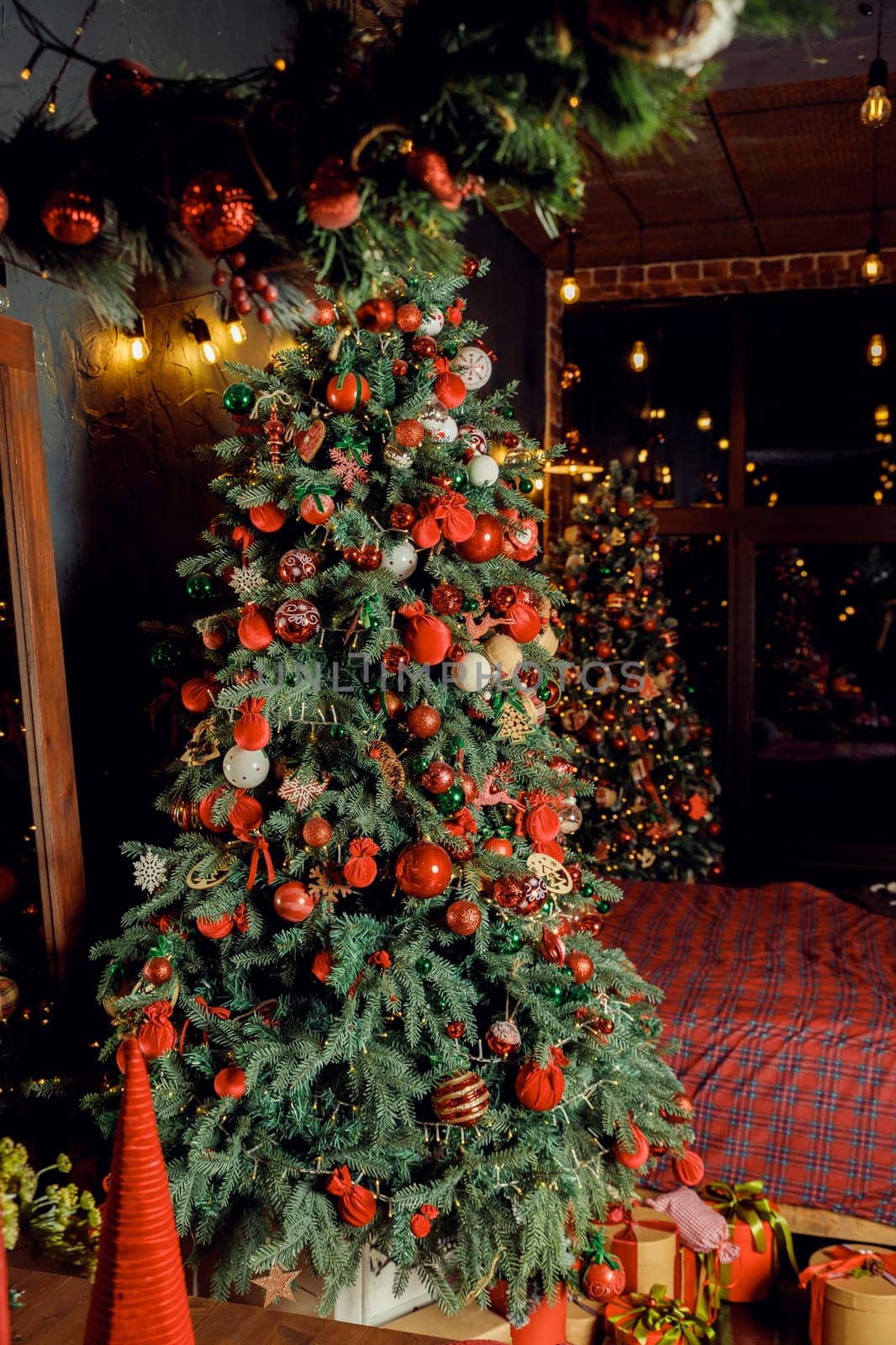 Classical Christmas decorated interior living room library with fireplace. Christmas tree with red golden ornament decorations.