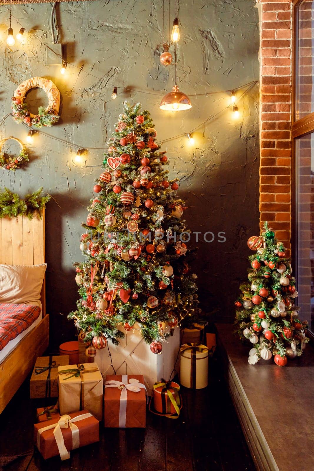 Classical Christmas decorated interior living room library with fireplace. Christmas tree with red golden ornament decorations.