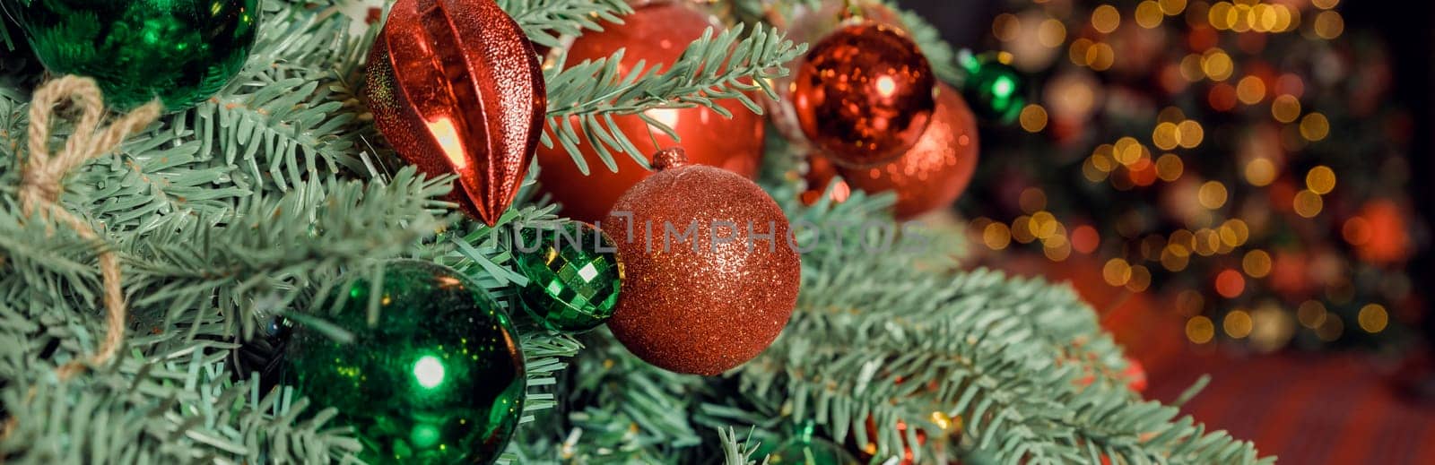 Christmas decorations on the holiday tree.Many colorful balls garland glowing lamps and red berries on the branches are sprinkled with snow.Festive traditional seamless background for the New Year by YuliaYaspe1979