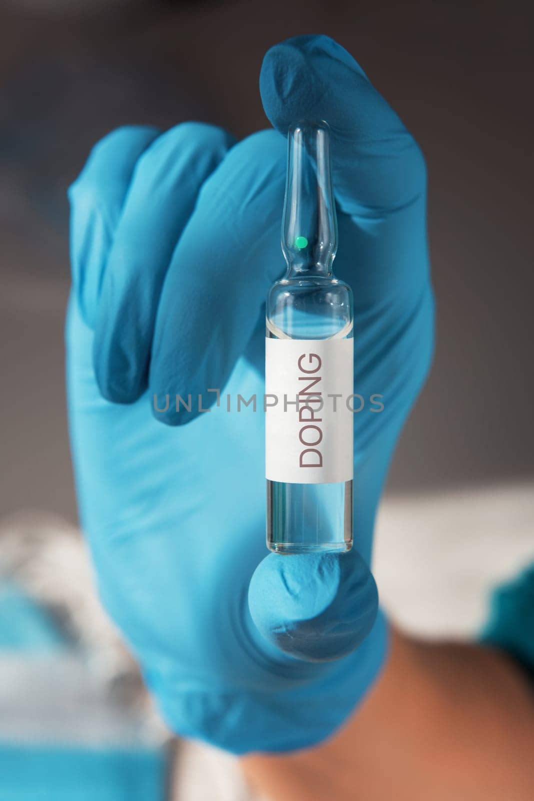 A doping ampoule in a nurse's hand closeup photo, sports doping addiction concept