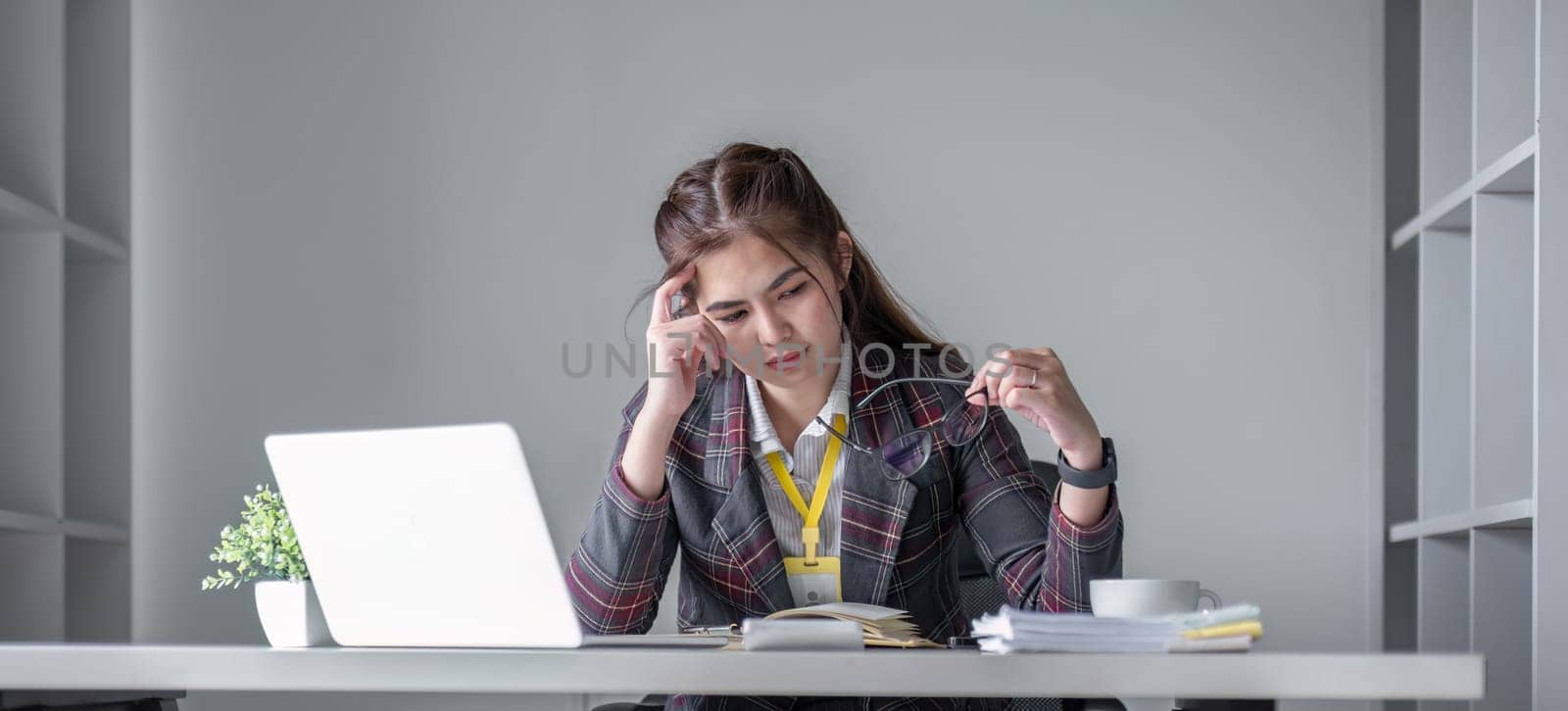 Businesswoman is stressed and tired from working all day at the office..