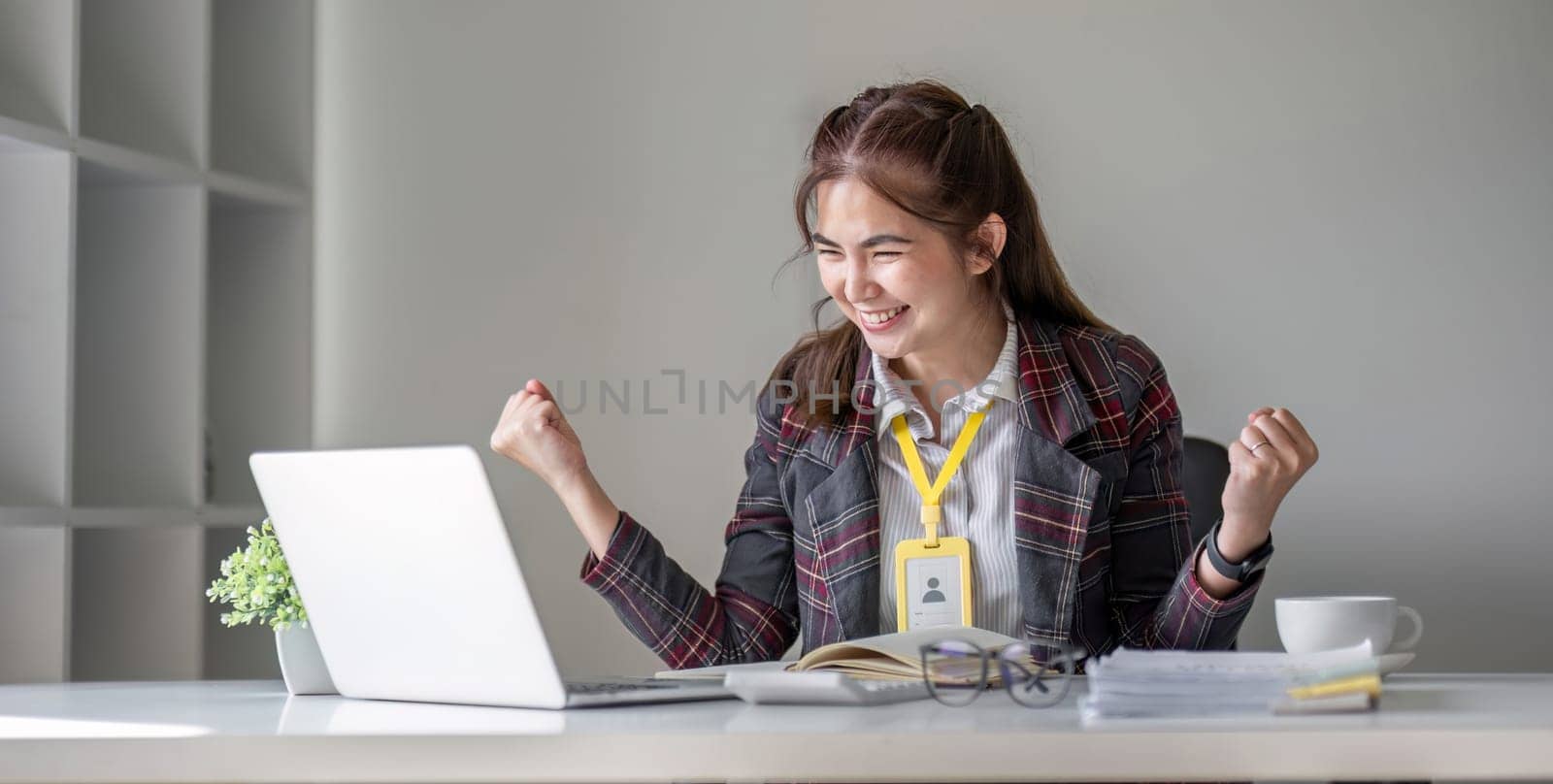 Cheerful and successful businesswoman celebrating with great satisfaction in the company..