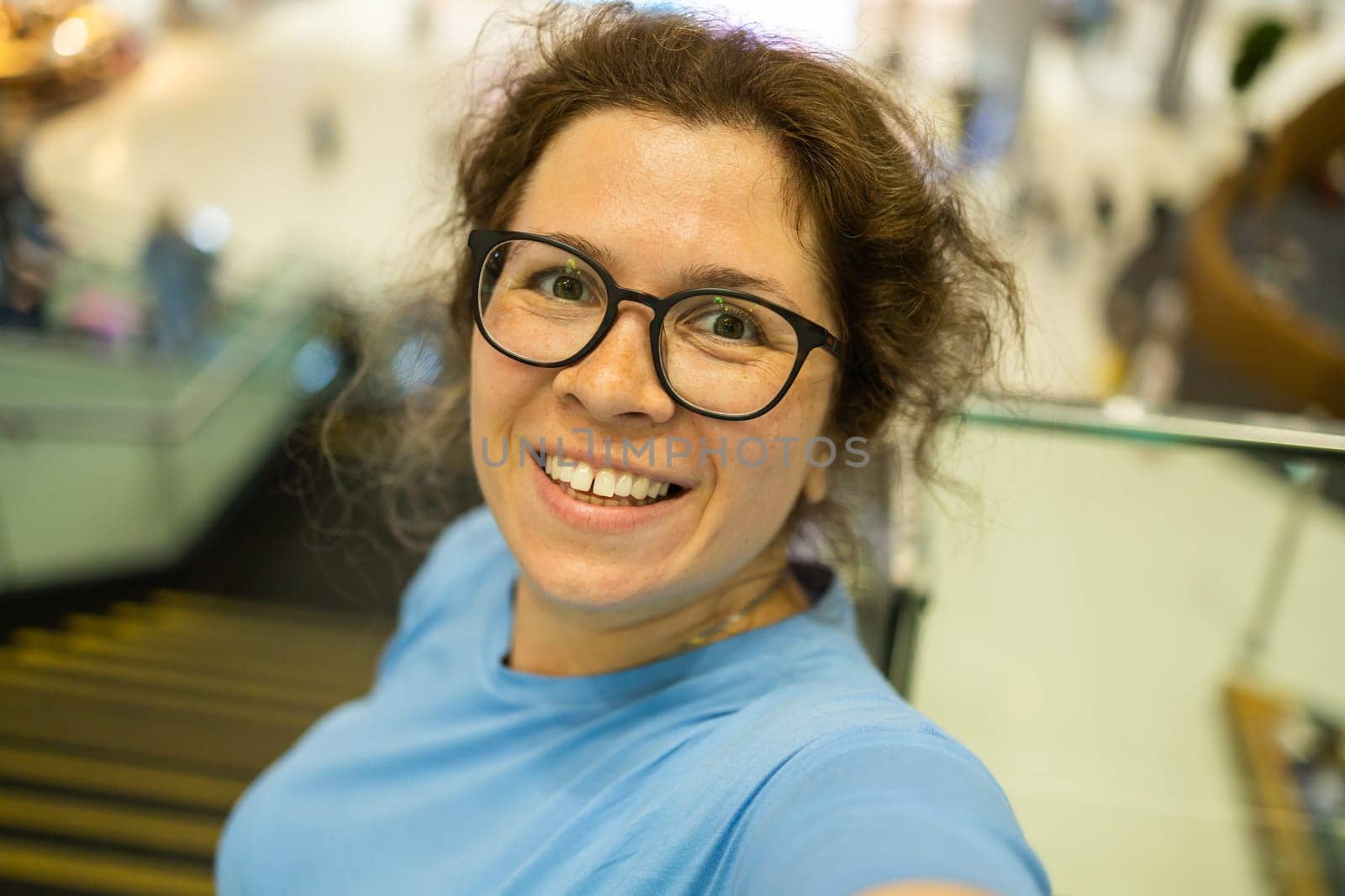 Video call portrait of excited cheerful smiling woman in spectacles taking selfie photo. Selfie and blogger