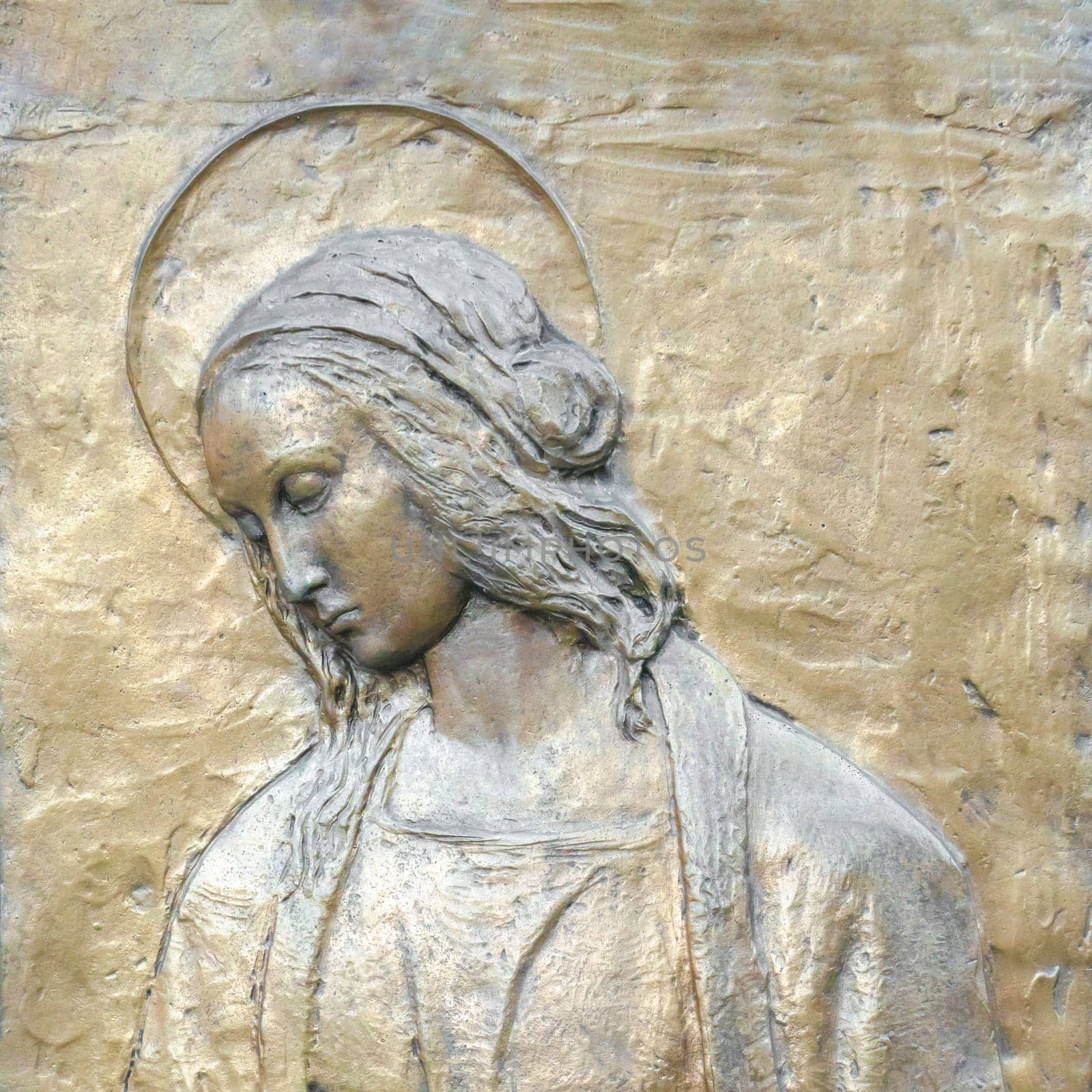 Relief of Our Lady. Bronze bas-relief of the Virgin Mary. Loss of the son Jesus. Sadness, pain, prayer.