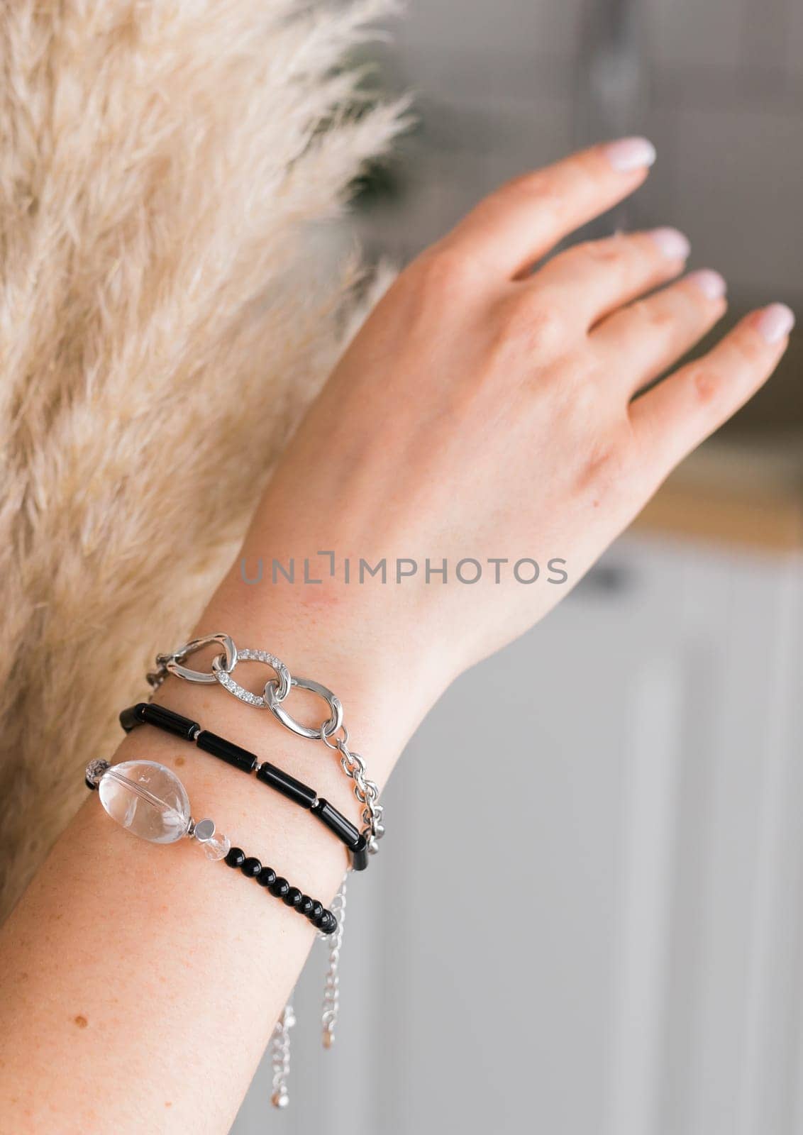 Close-up woman wearing beautiful luxury rings and bracelet. Handmade jewellery and accessories.
