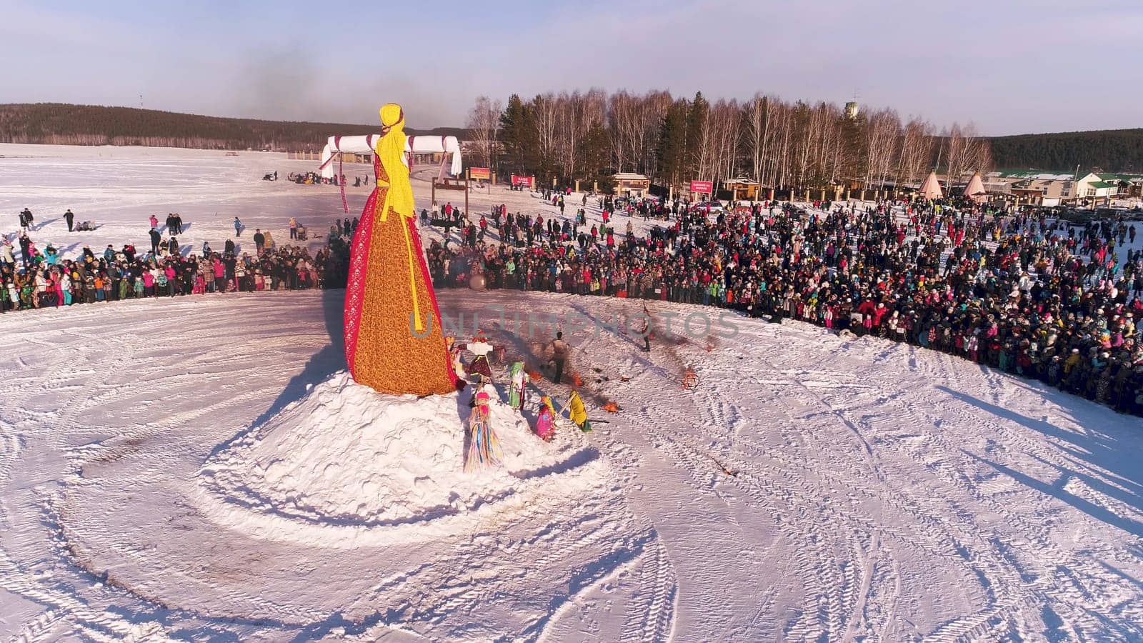 Moscow, Russia - February 26, 2018: Russian traditional celebration Maslenitsa. People celebrate Maslenitsa and relax in countryside. Burning Scarecrow by Mediawhalestock