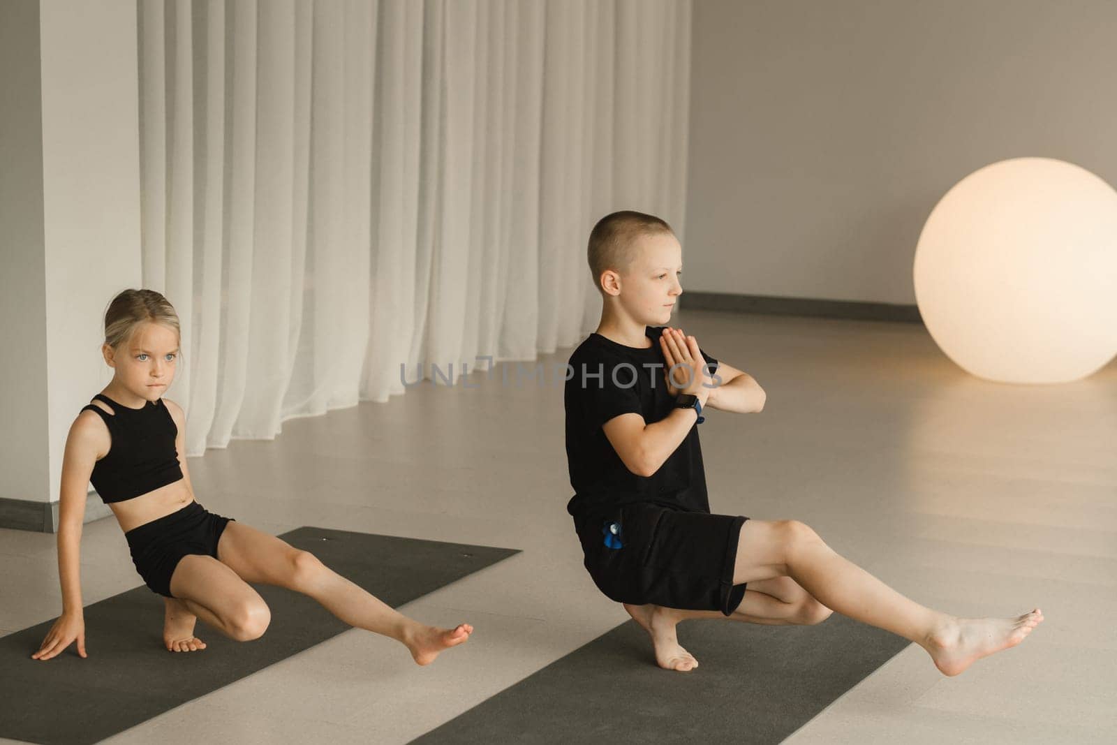 Children do Yoga in the fitness room. Children's gymnastics.