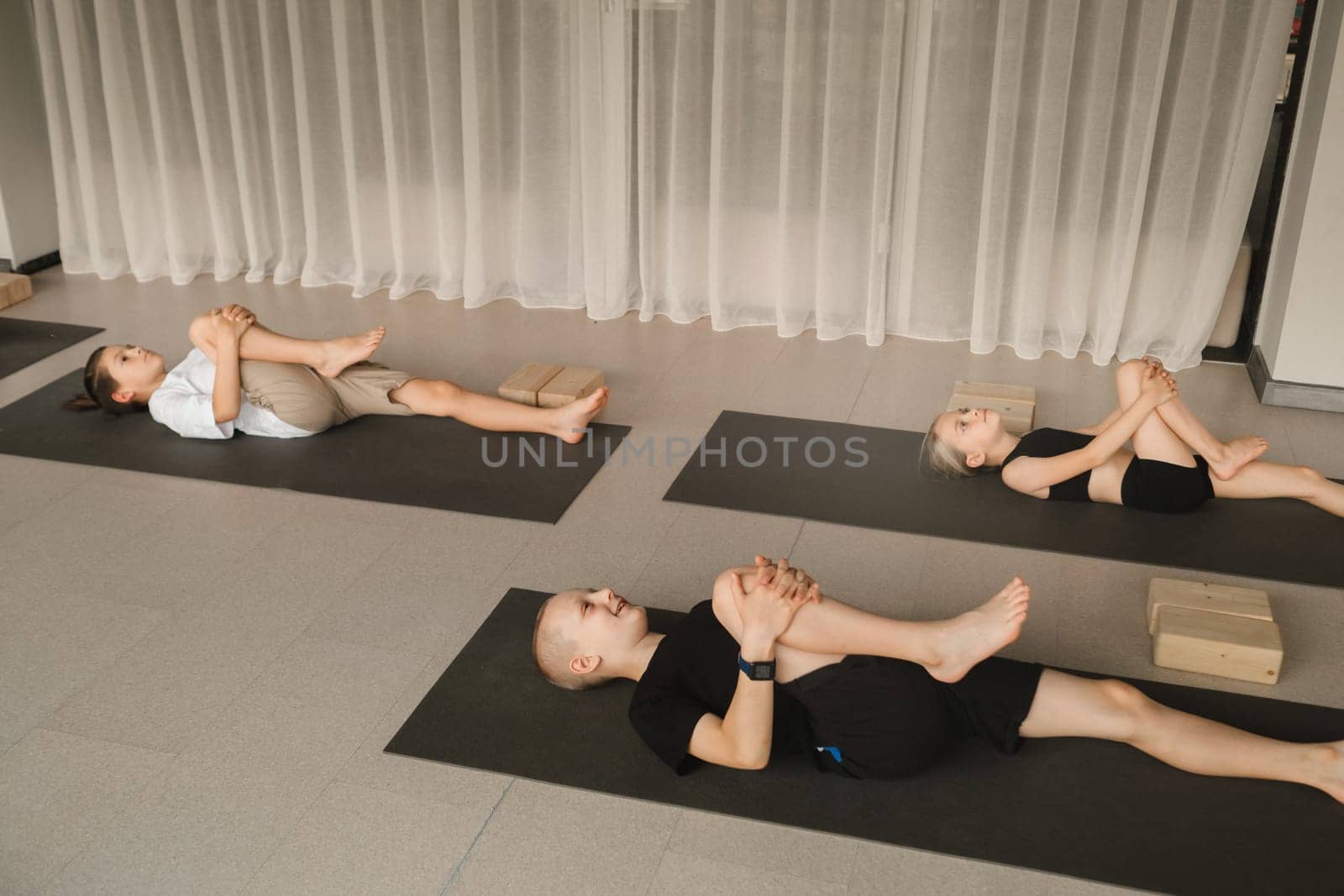 Children do Yoga in the fitness room. Children's gymnastics.