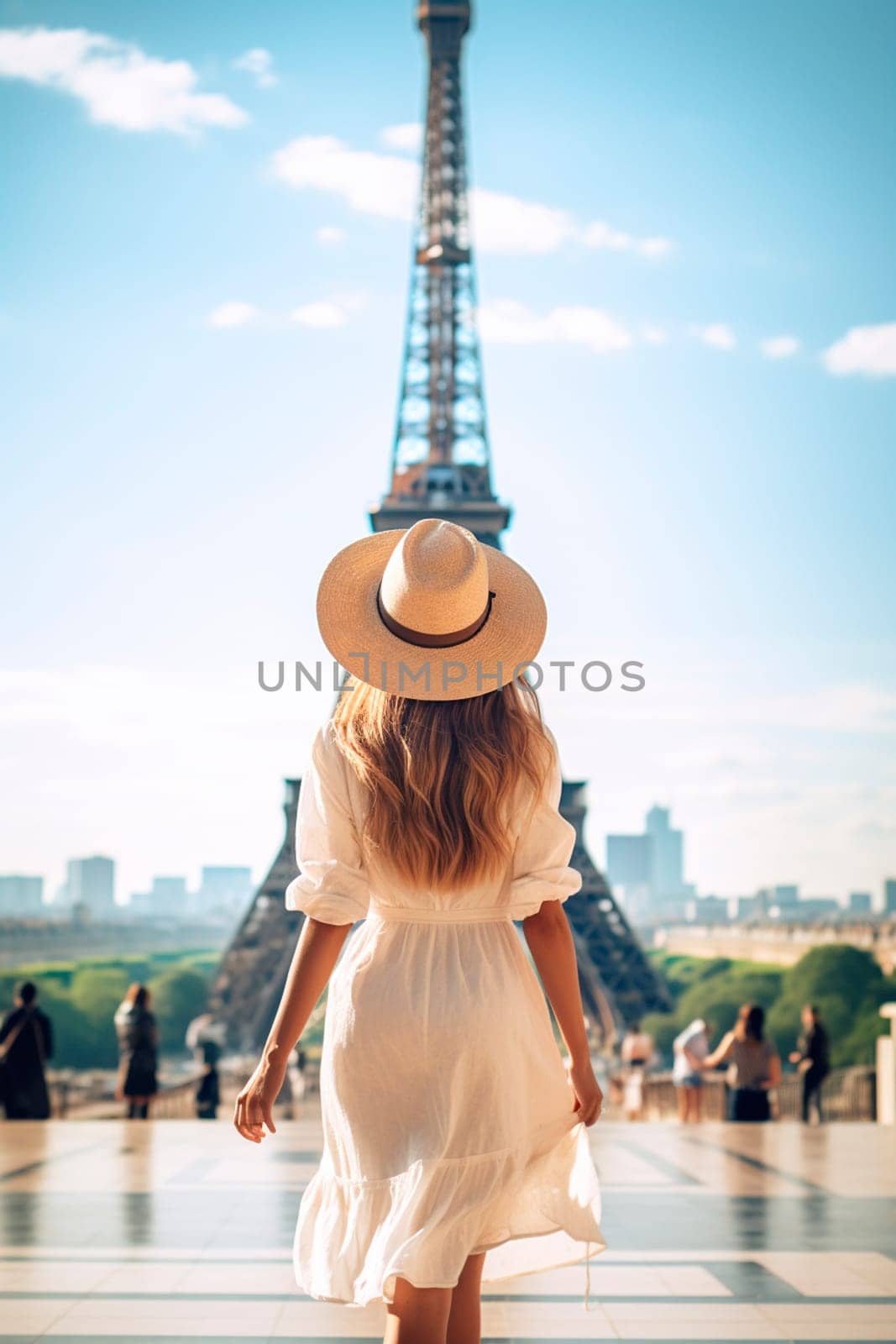 A woman in a hat looks at the Eiffel Tower. Selective focus. by yanadjana