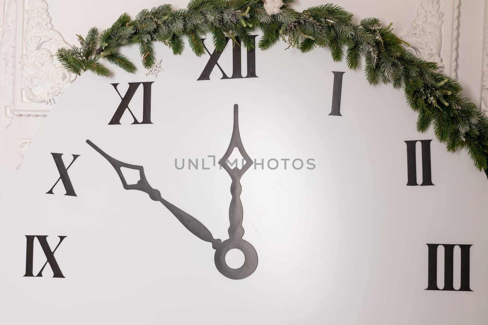 Layout clock. Dial with Roman numerals. Textured brown planks wood base. Black hands of the clock show the time - seven minutes to twelve. New Year holiday concept. by YuliaYaspe1979