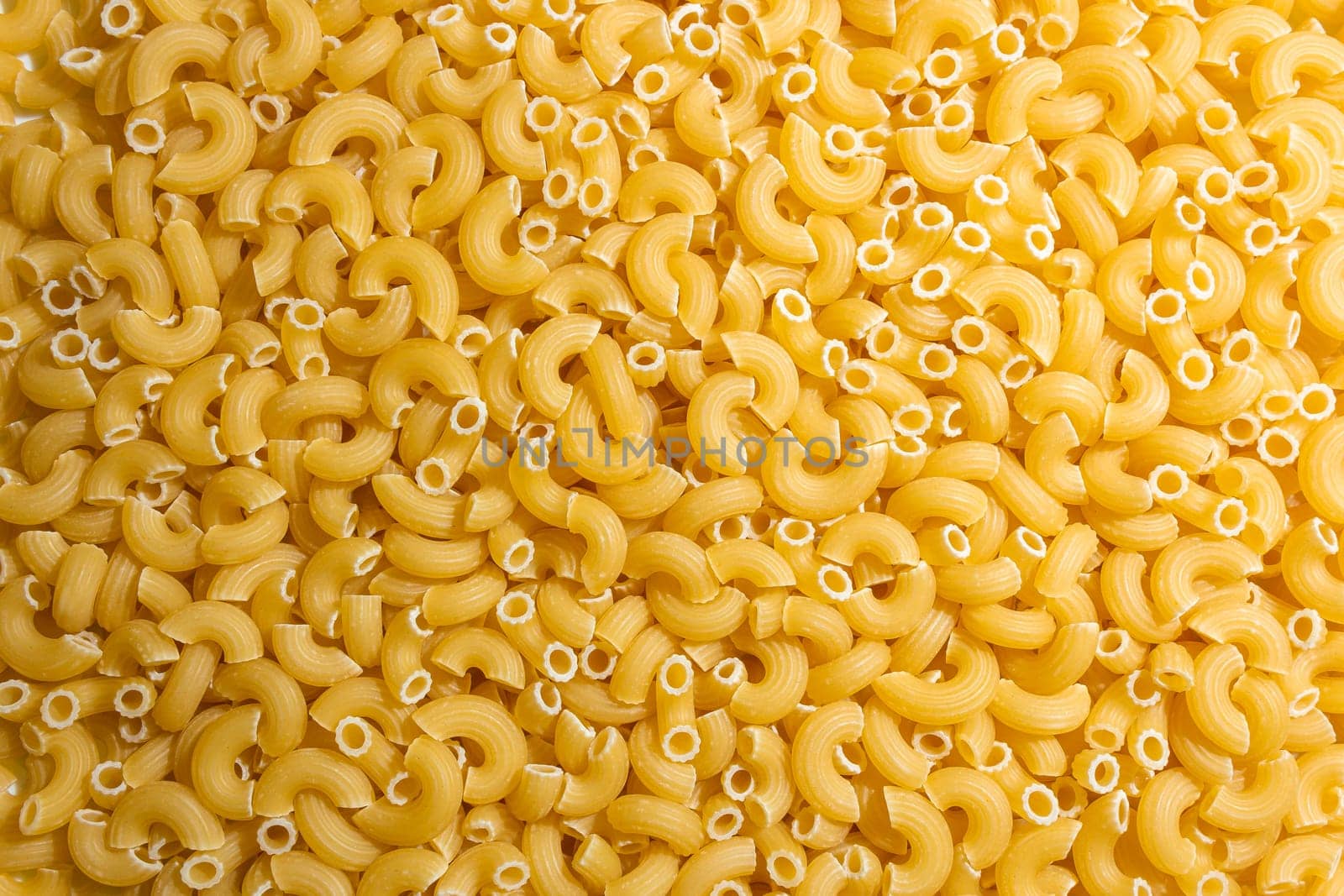 Uncooked Chifferi Rigati Pasta: A Culinary Canvas of Chifferi Rigati, Creating a Lively and Textured Background for Gourmet Cooking. Dry Pasta. Raw Macaroni - Top View, Flat Lay