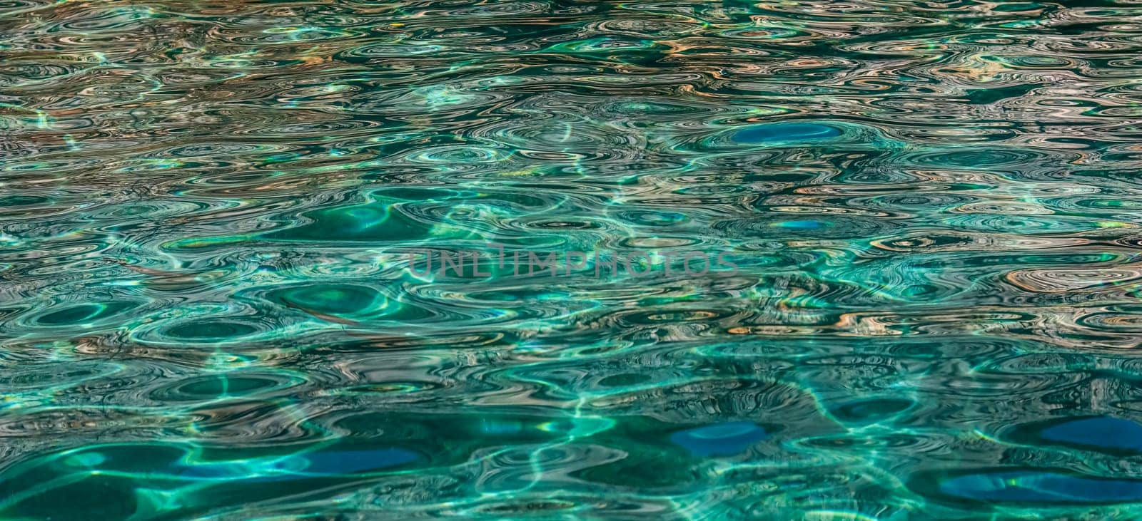 Emerald sea in sunshine glow as surface background. Summer holidays concept by Olayola