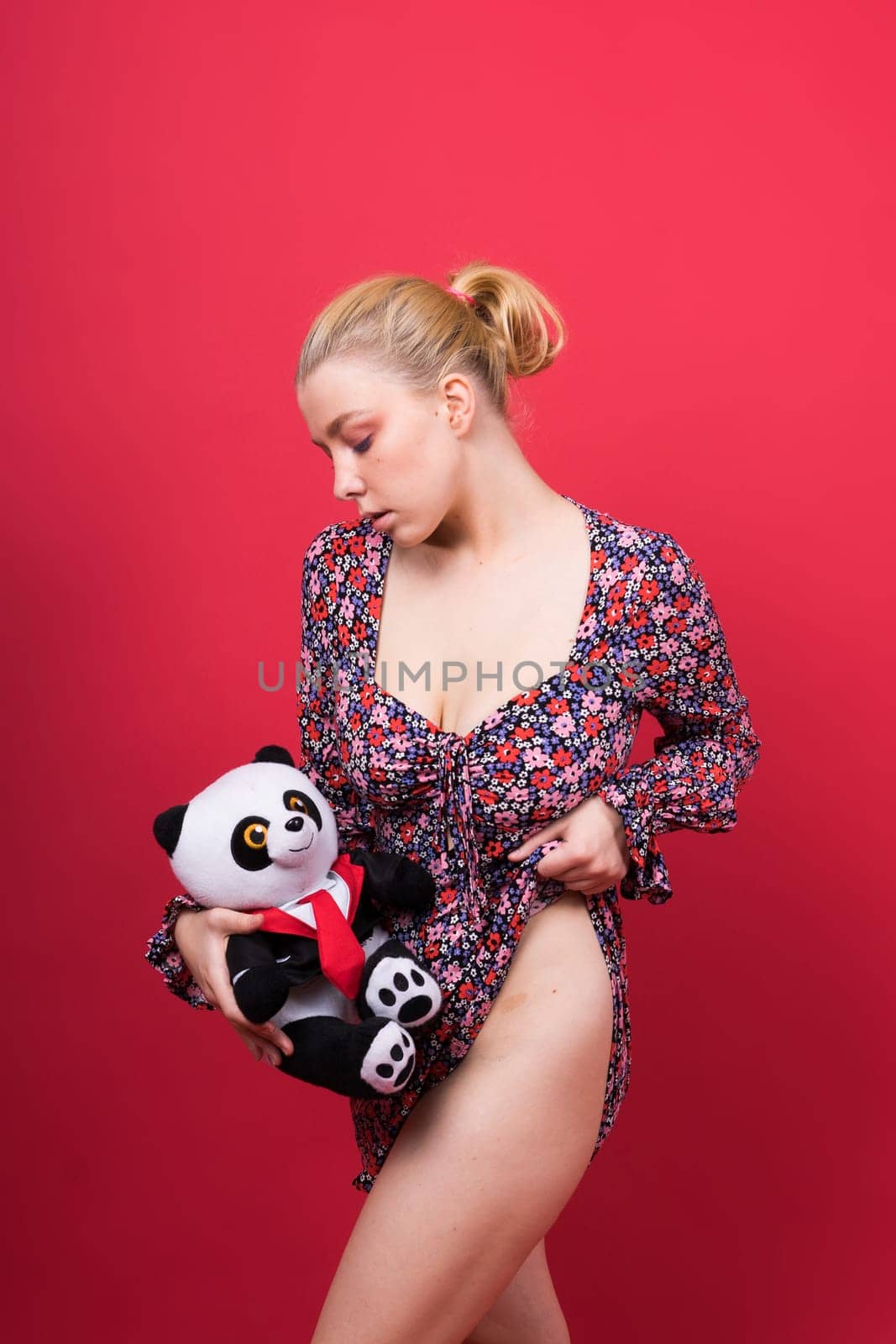 Portrait of seductive woman posing in a studio with panda