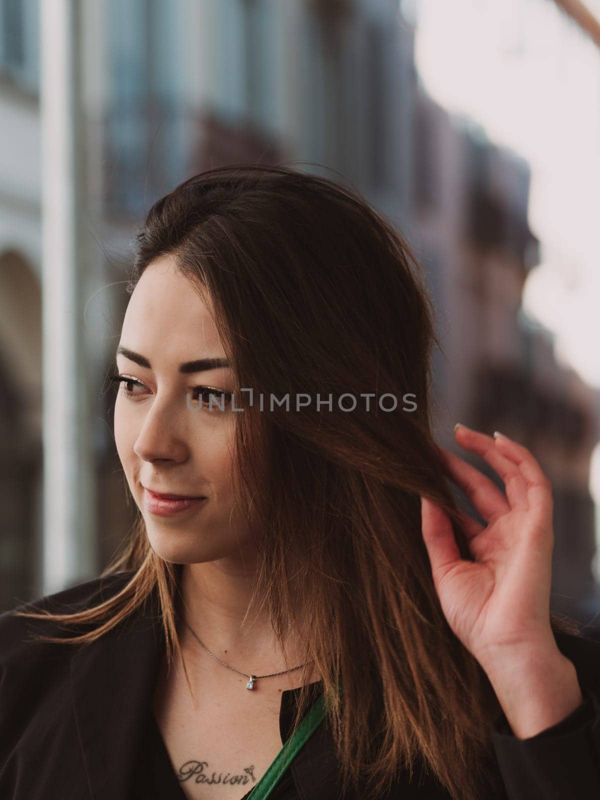 street portrait of long haired brunette standing outdoors, mixed asian race female model, looking thoughtful and confident, film look