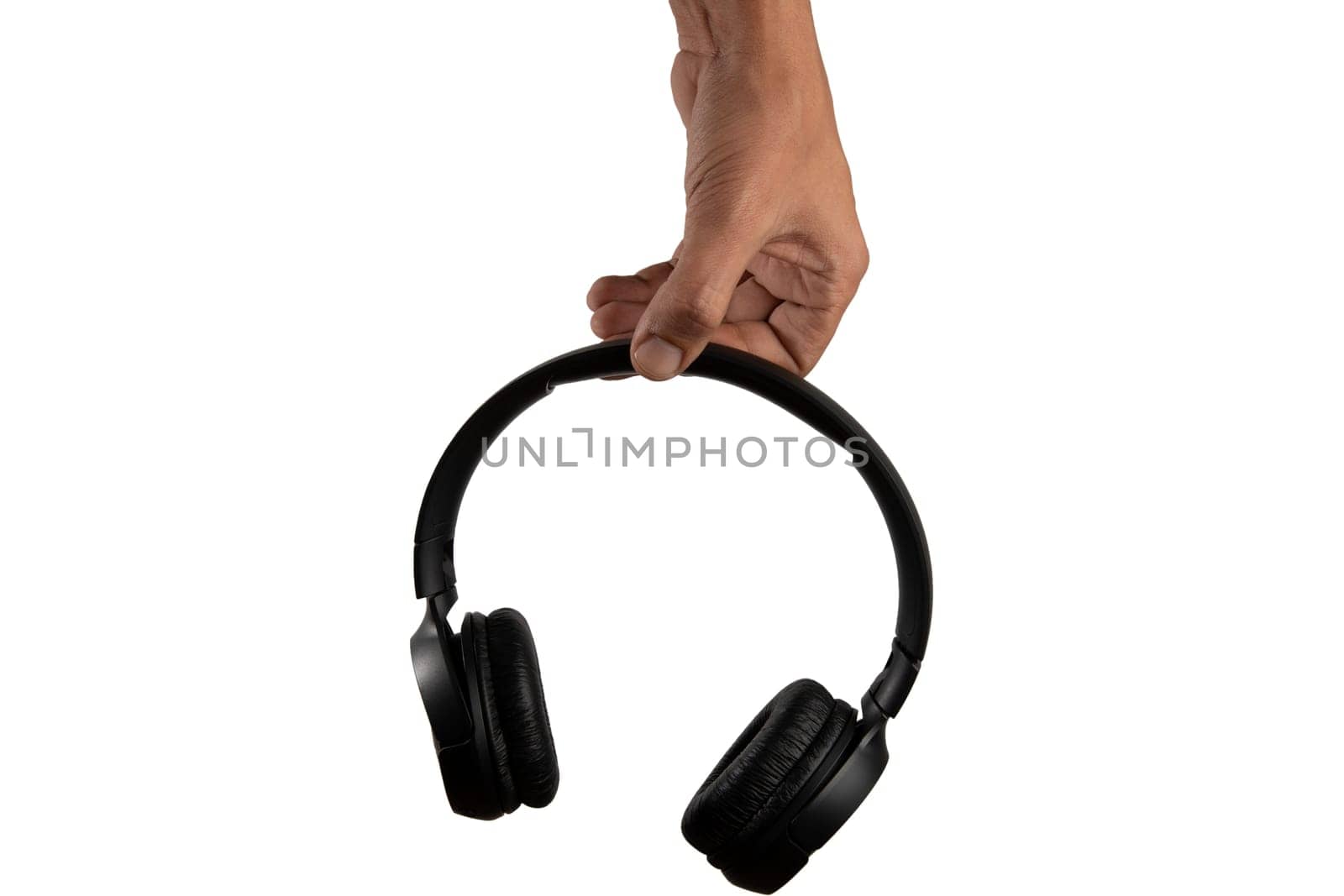 black male hand holding stereo headphones isolated on white background. by TropicalNinjaStudio