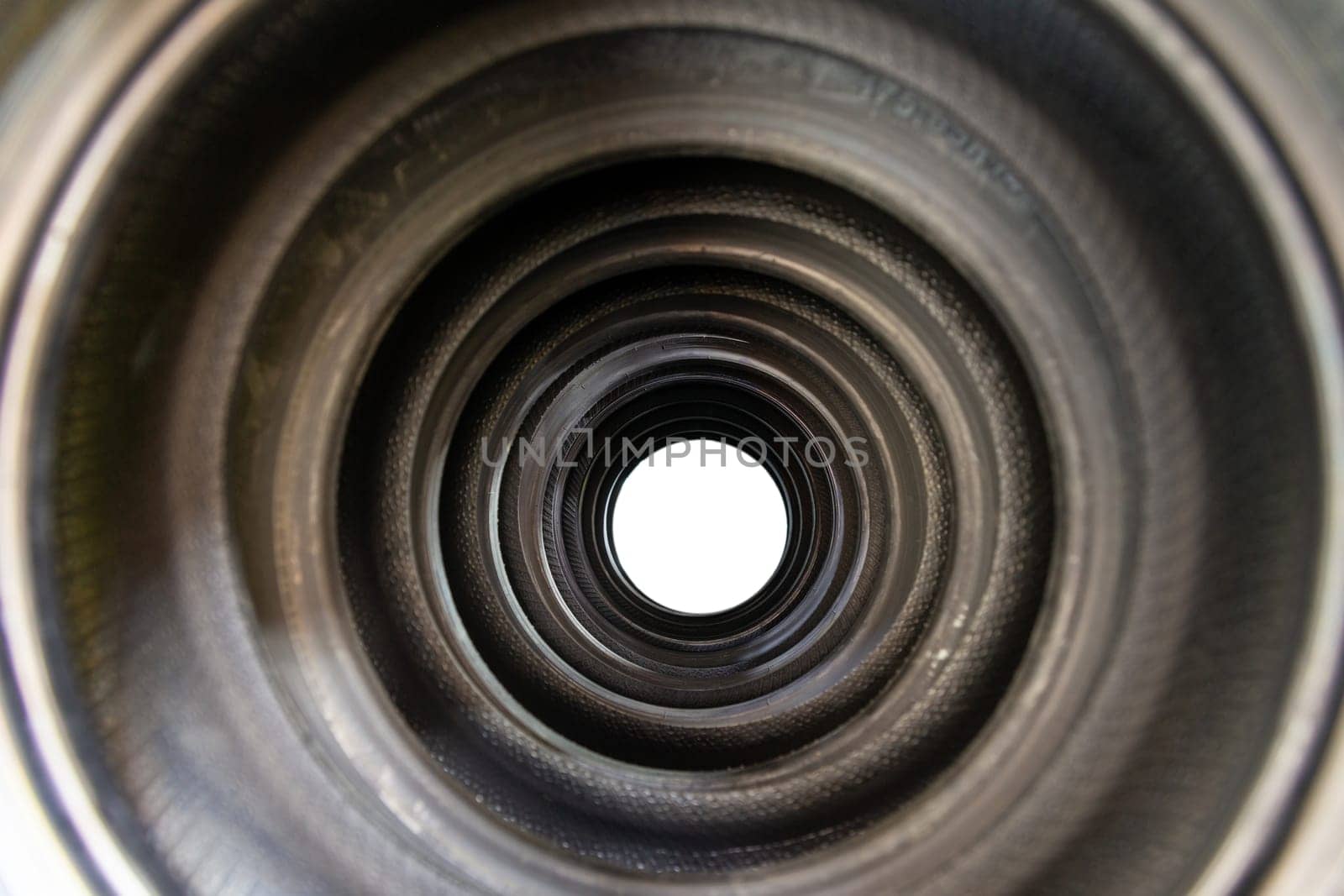 A tunnel of new car tires standing on a store counter with concentrated rings by BY-_-BY