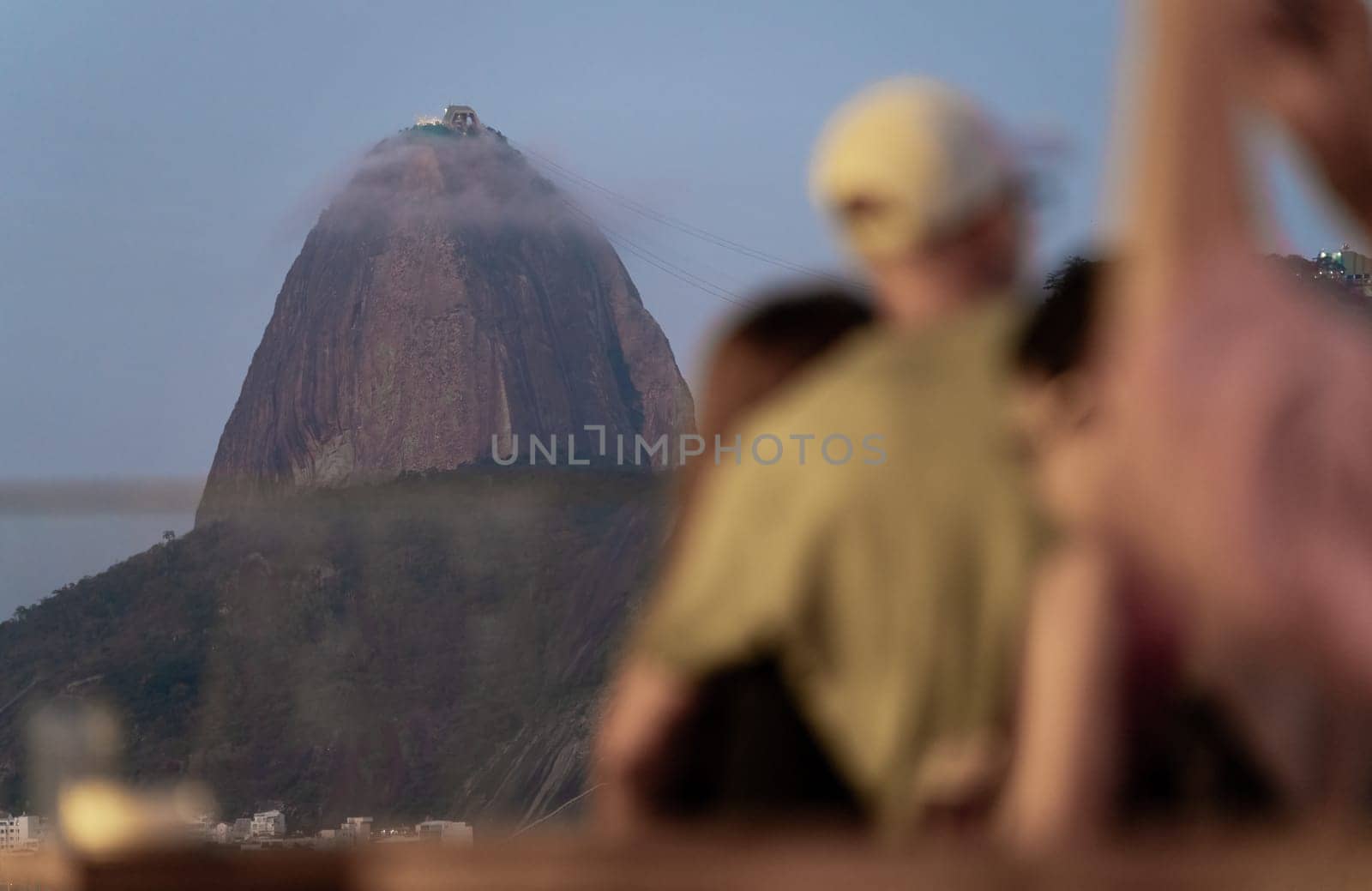 Viewers admire misty Sugarloaf Mountain at a peaceful twilight.
