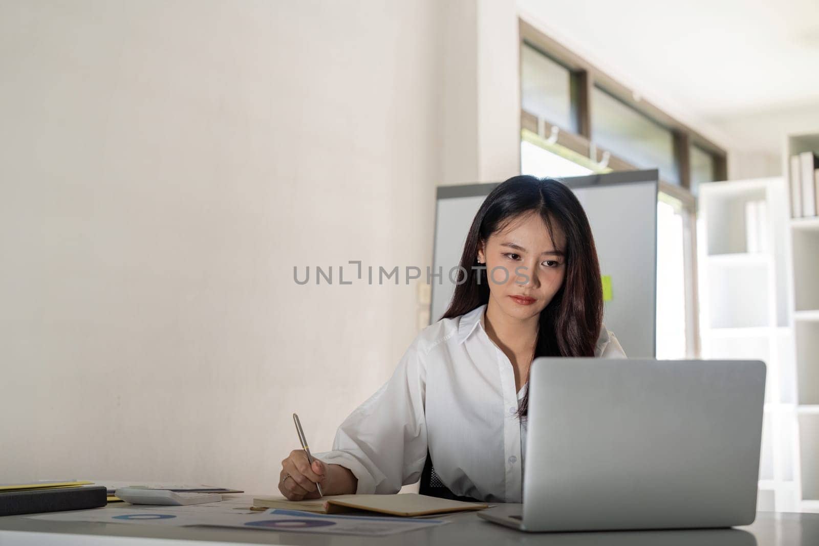 Business woman doing finance on desk in office and business working, tax, accounting, statistics and analytic research concept.